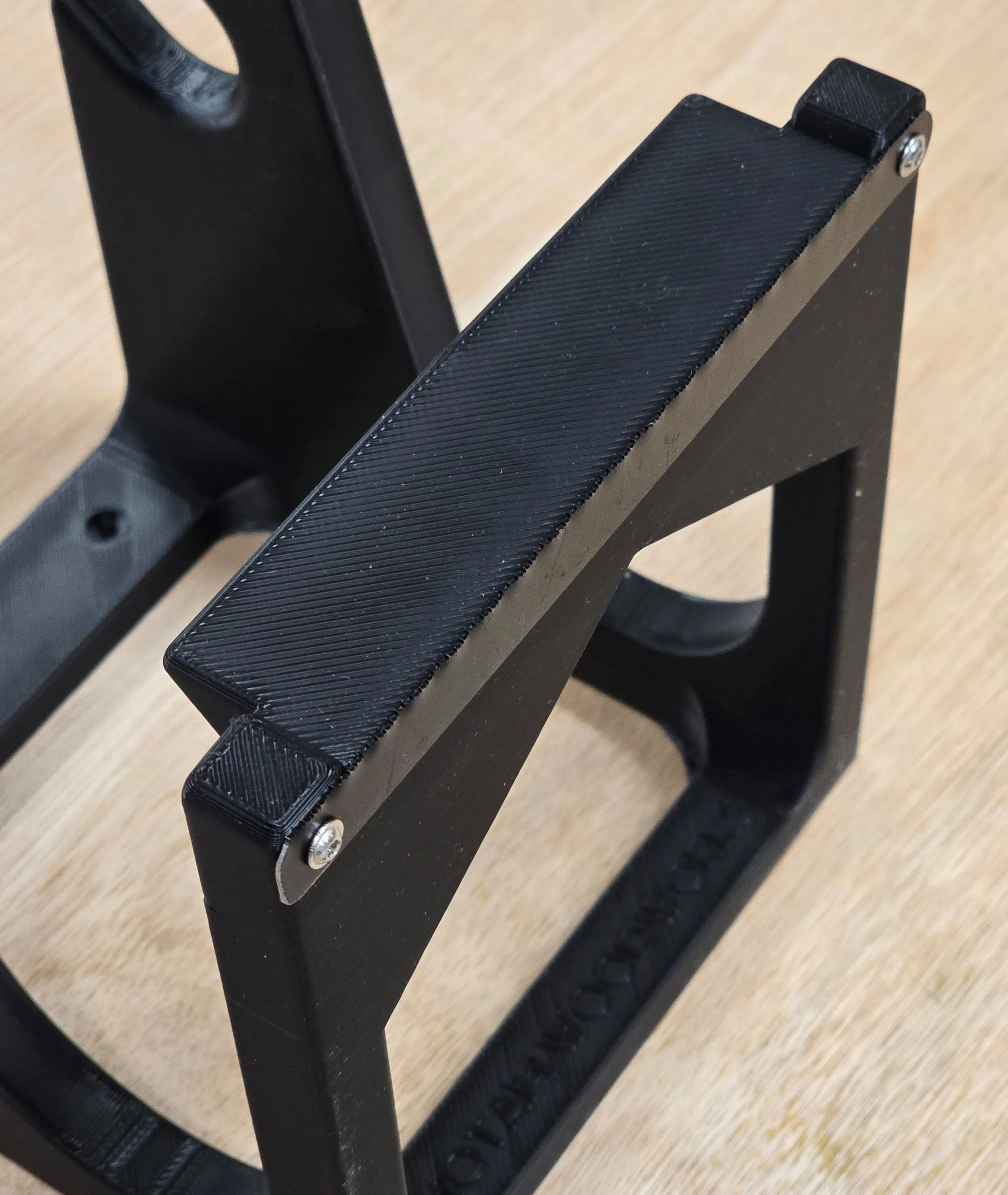 The Motam Woodworks sandpaper roll storage bracket on its own, showing the cutting blade