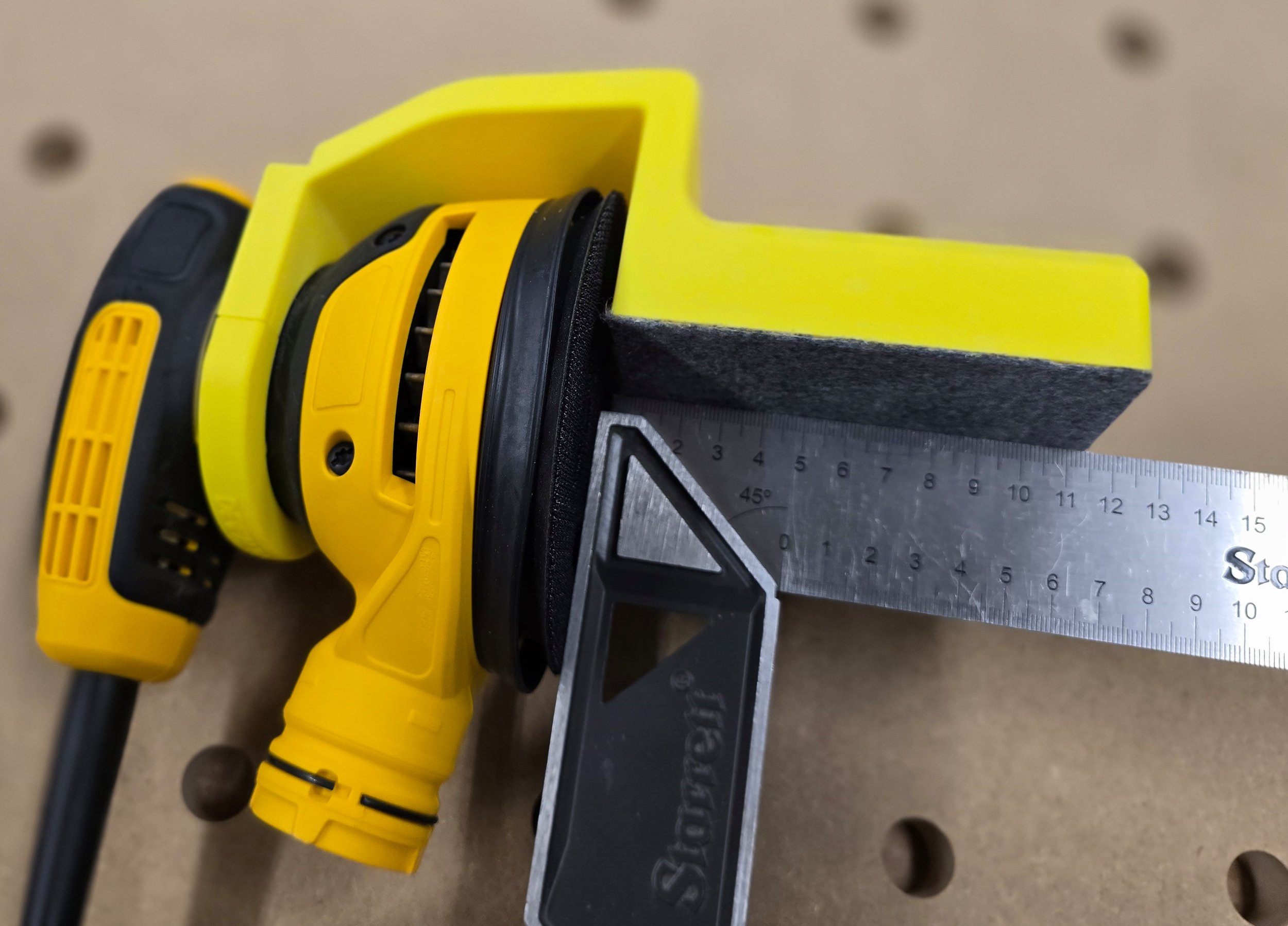 An engineer's square checking the guide's 90-degree accuracy against the sander