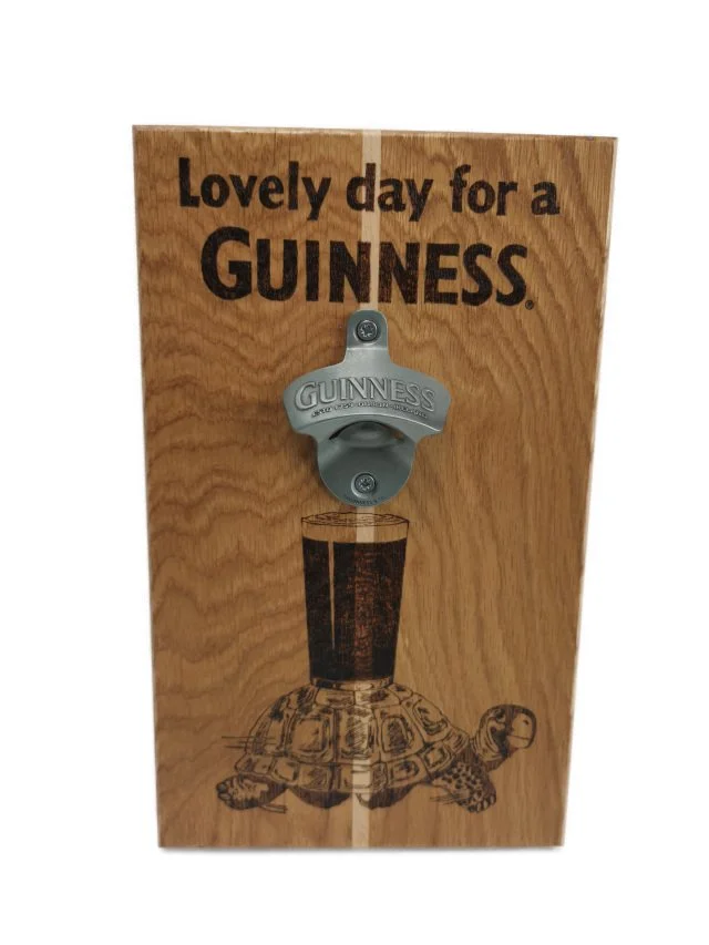 Oak wall-mounted Guinness bottle opener wood-burned with a tortoise carrying a pint of Guinness, straight-on view