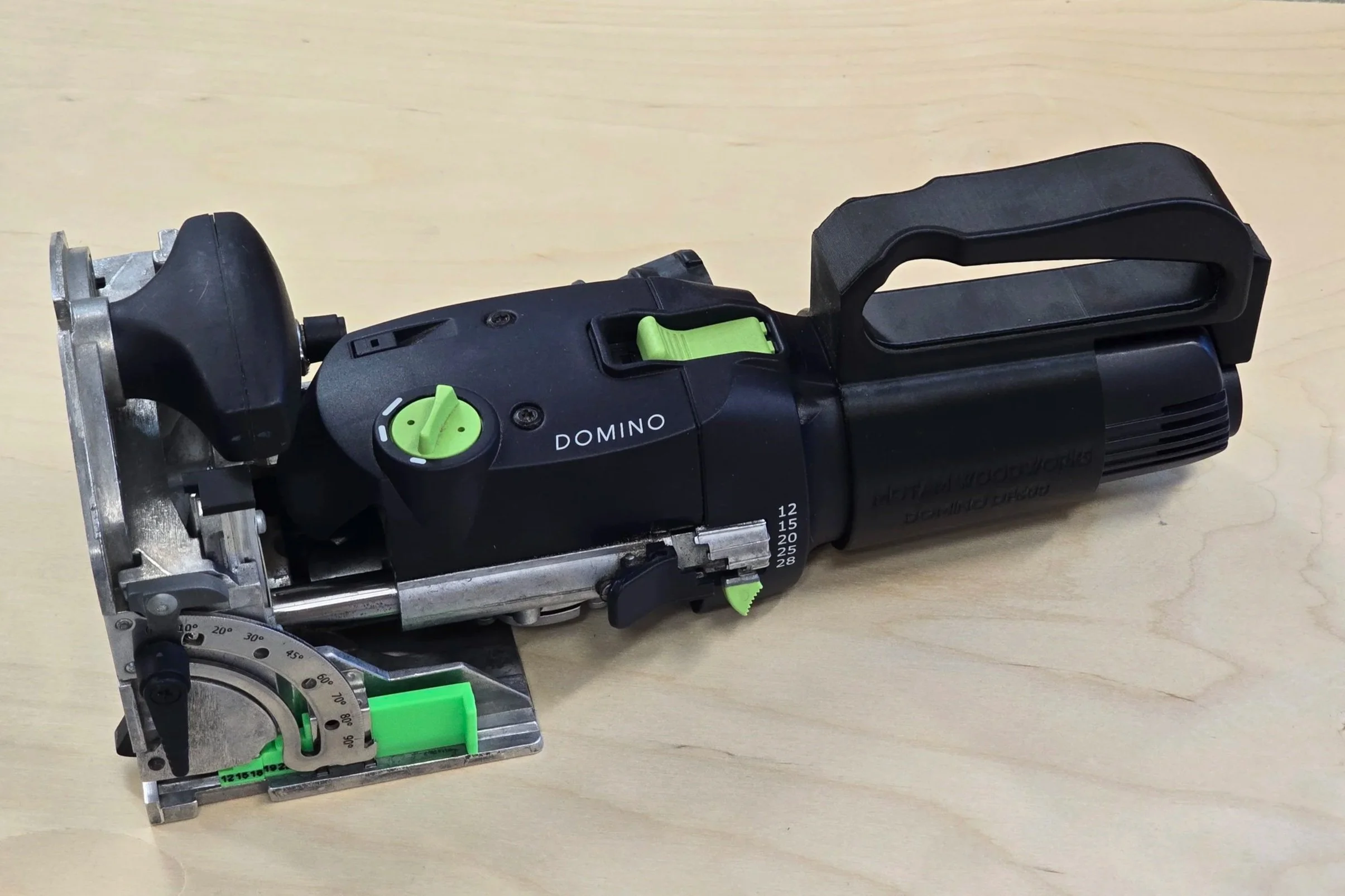 The D-Handle MK2 fitted to the rear of a Festool Domino DF 500 Q, embossed "Motam Woodworks Domino DF500"