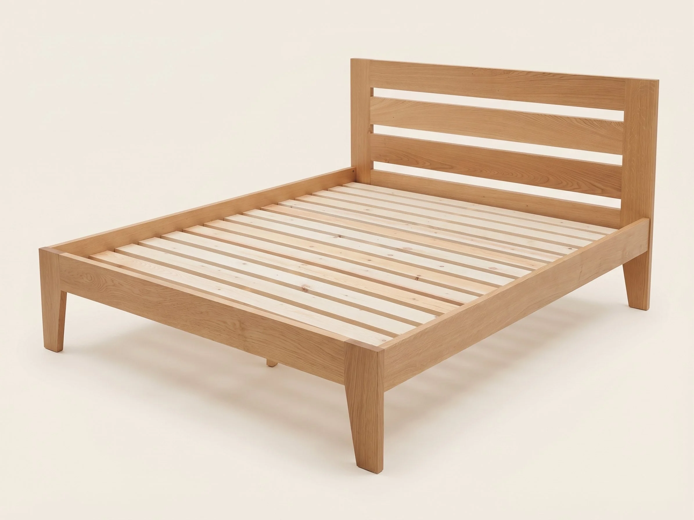 A wooden bed frame with slatted base and headboard, positioned against a plain white background.