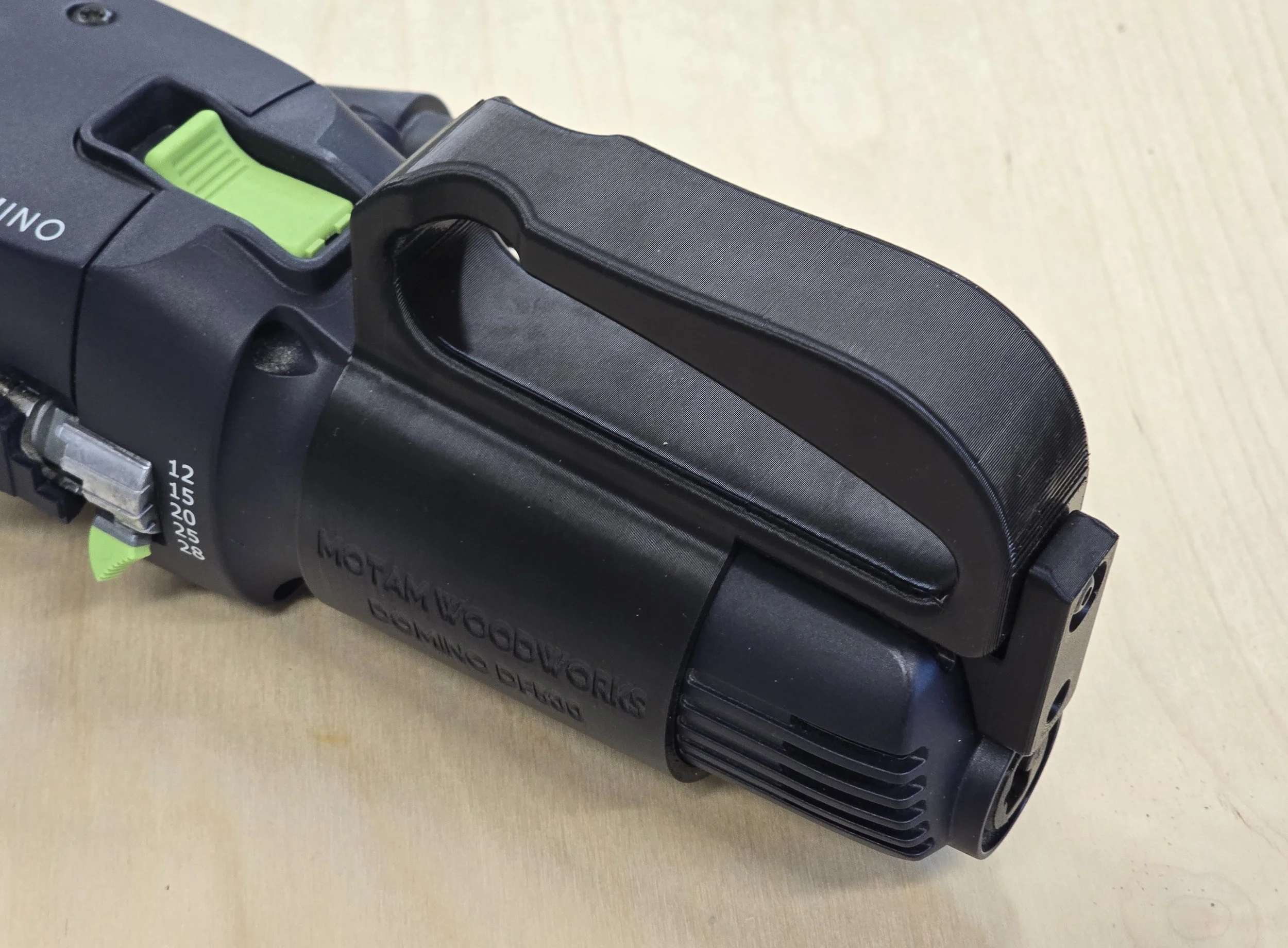 Close-up of the D-Handle MK2 mounted on the Domino DF 500, showing its friction-fit ergonomic shape