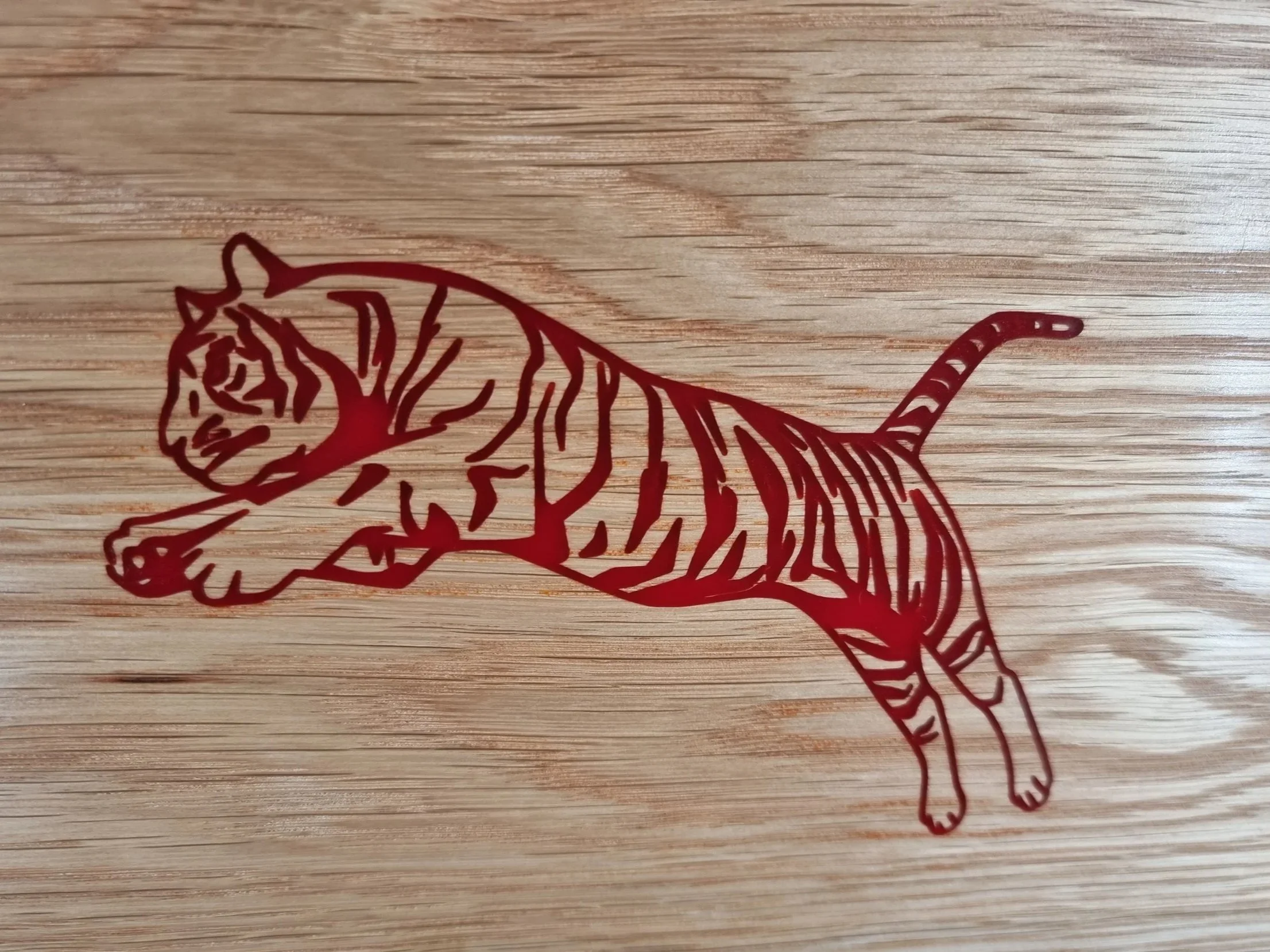 Red tiger inlaid into an oak panel, custom wooden sign