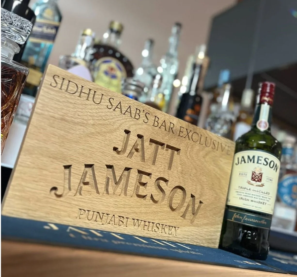 Personalised oak bar sign, carved with "Jatt Jameson Punjabi Whiskey"