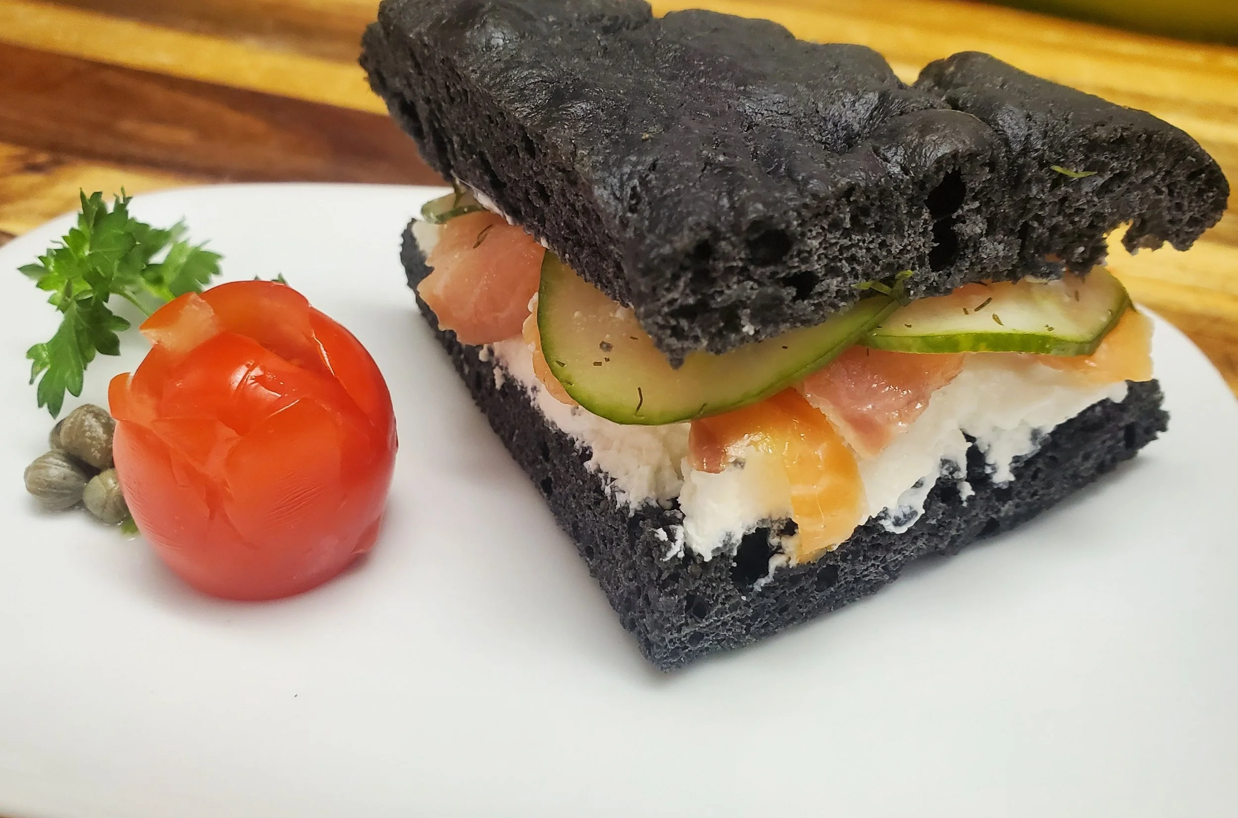 Smoked salmon, labnah and fresh cucumber pickle on black focaccia