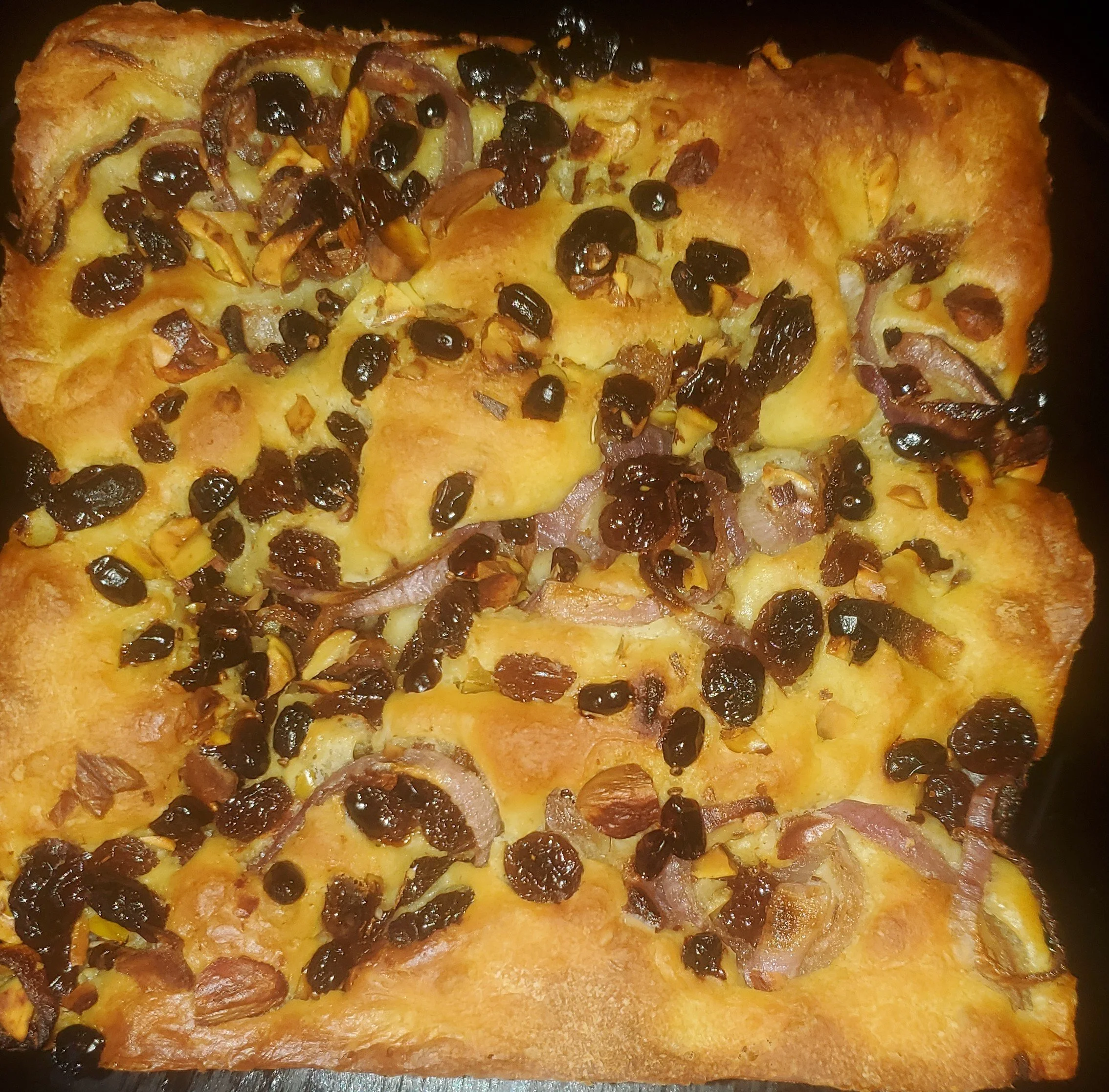 Saffron focaccia with raisins, onion, barberries and garlic