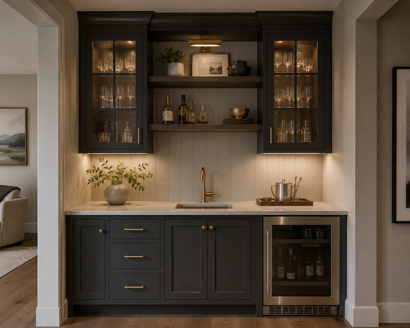 A small home bar area with dark cabinetry, a marble countertop, and glassware display cabinets, featuring a gold faucet, potted plant, and beverages including wine and liquor bottles.