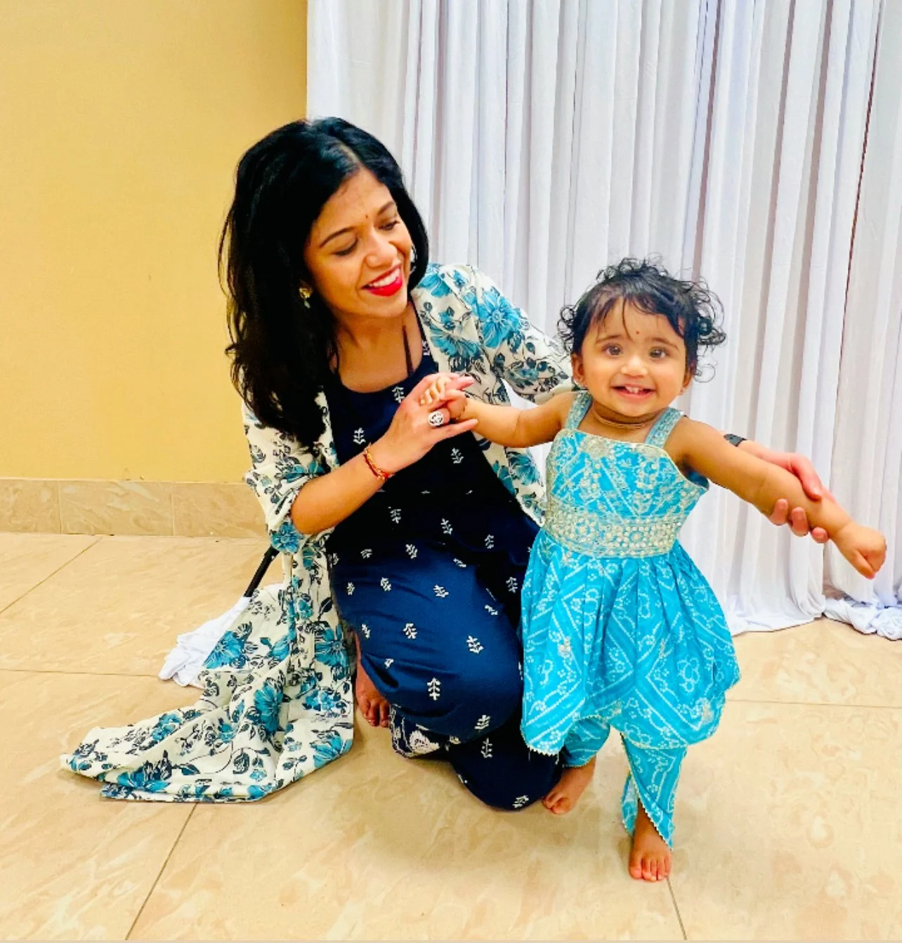 Nishi and her daughter wearing a traditional south asian outfit.