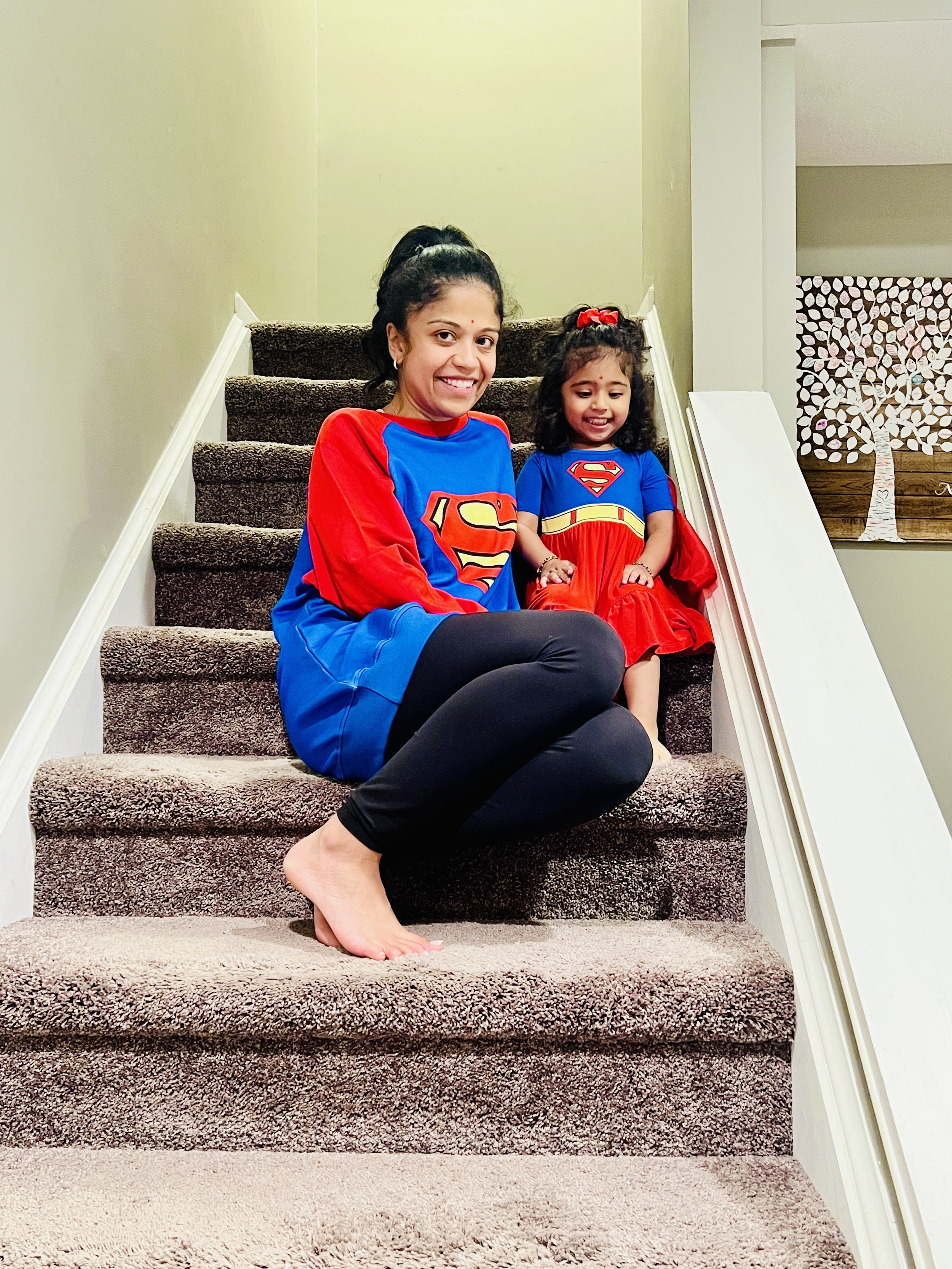 Nishi Jani Rajguru and her daughter dressed as  superwoman and supergirl for halloween.