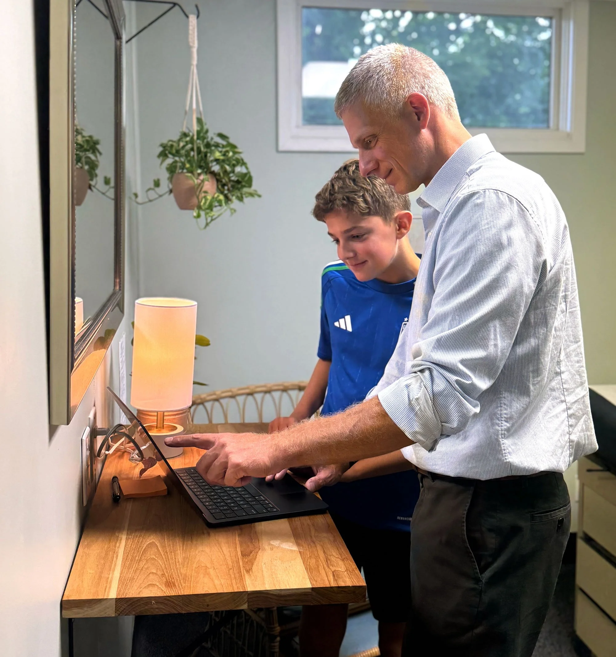 Physician and patient looking at laptop screen together