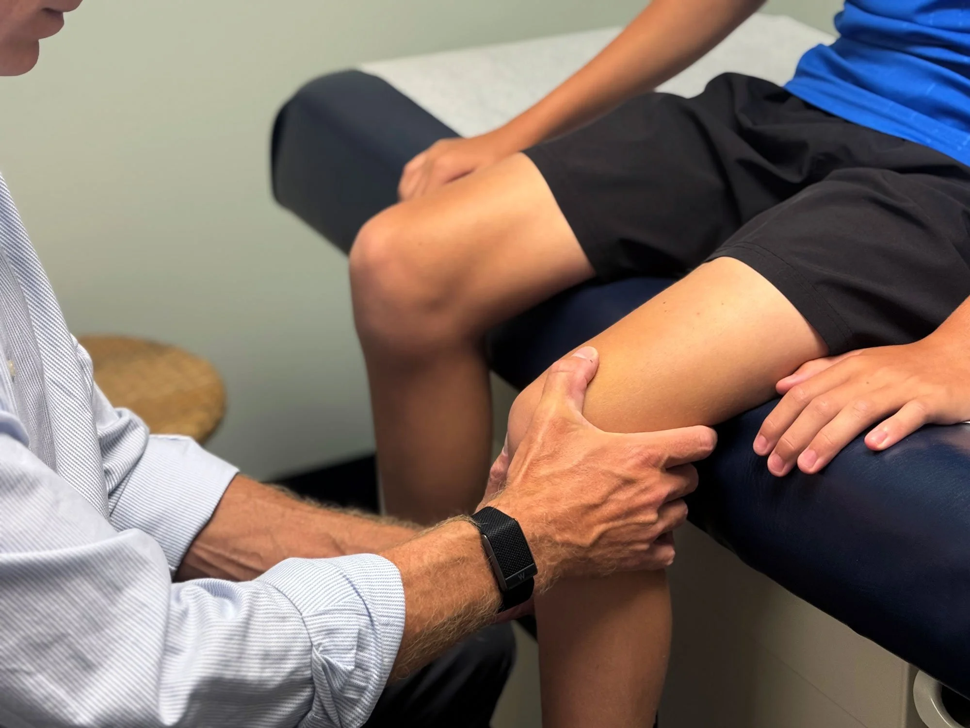 Physicians hands examining child's knee