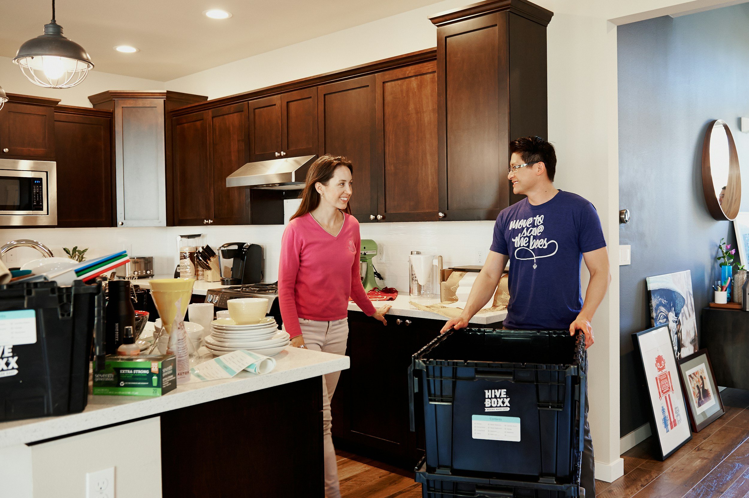 Home service professional speaking with a customer in her kitchen