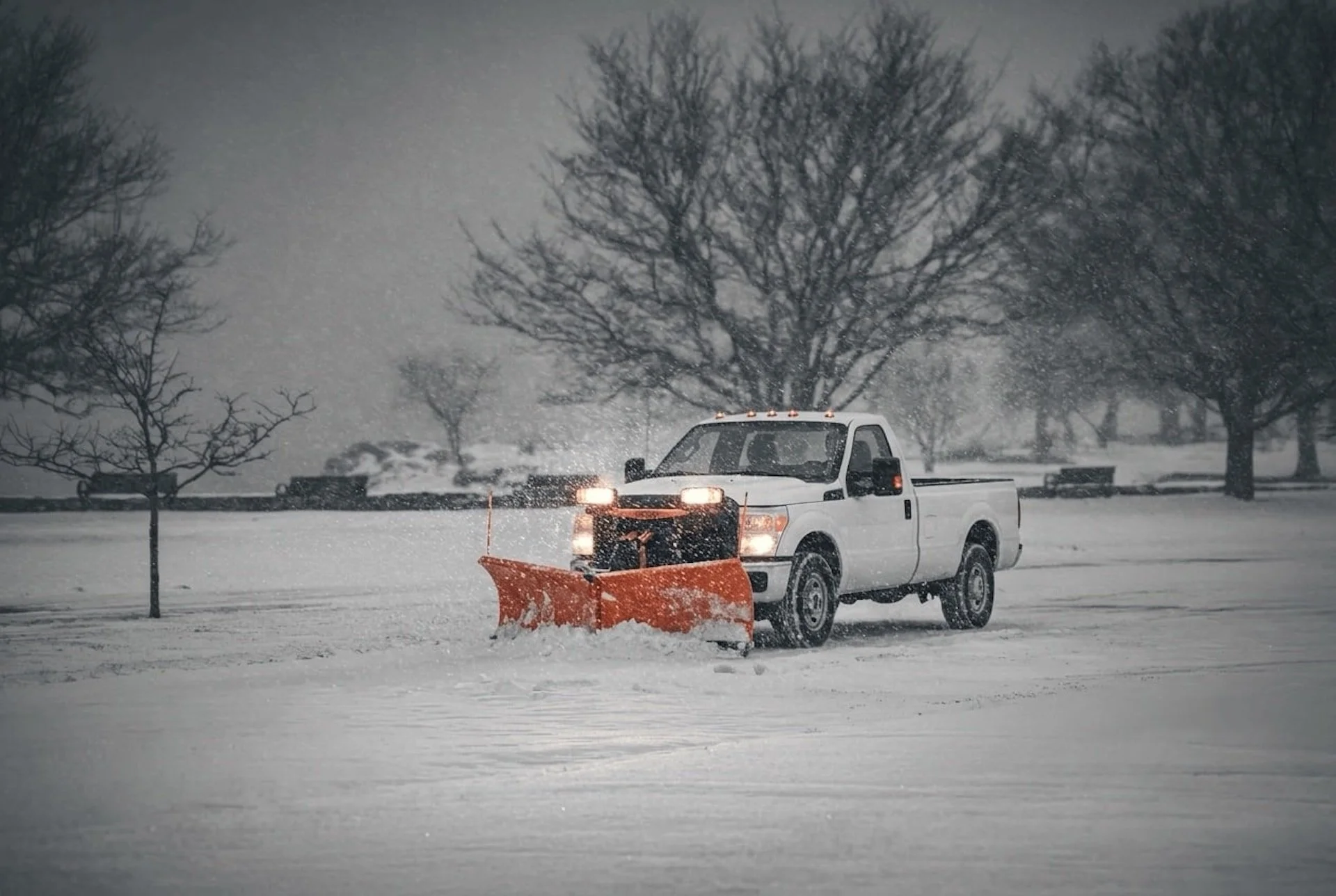 Truck plowing a parking lot in Clifton Park, NY