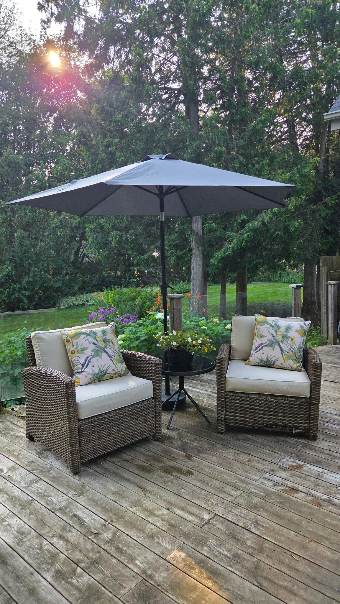 A peaceful outdoor deck with seating and a garden view — a restful setting for reflection at retreats and intensives with Amy Tremblay in the Georgian Bay area.