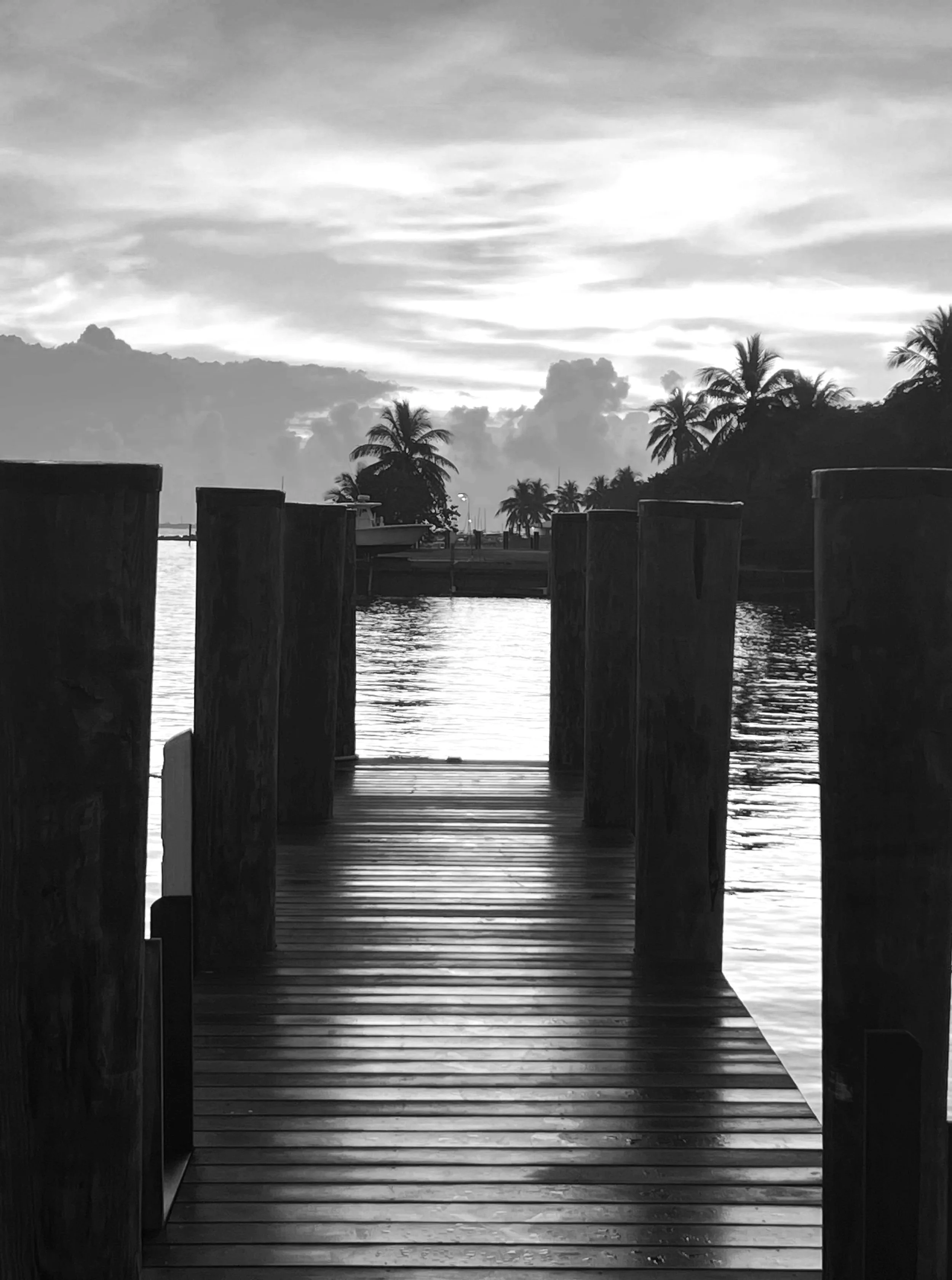 A black and white photo of a quiet dock at sunset — couples therapy and intensives with Amy Tremblay in the Georgian Bay area.