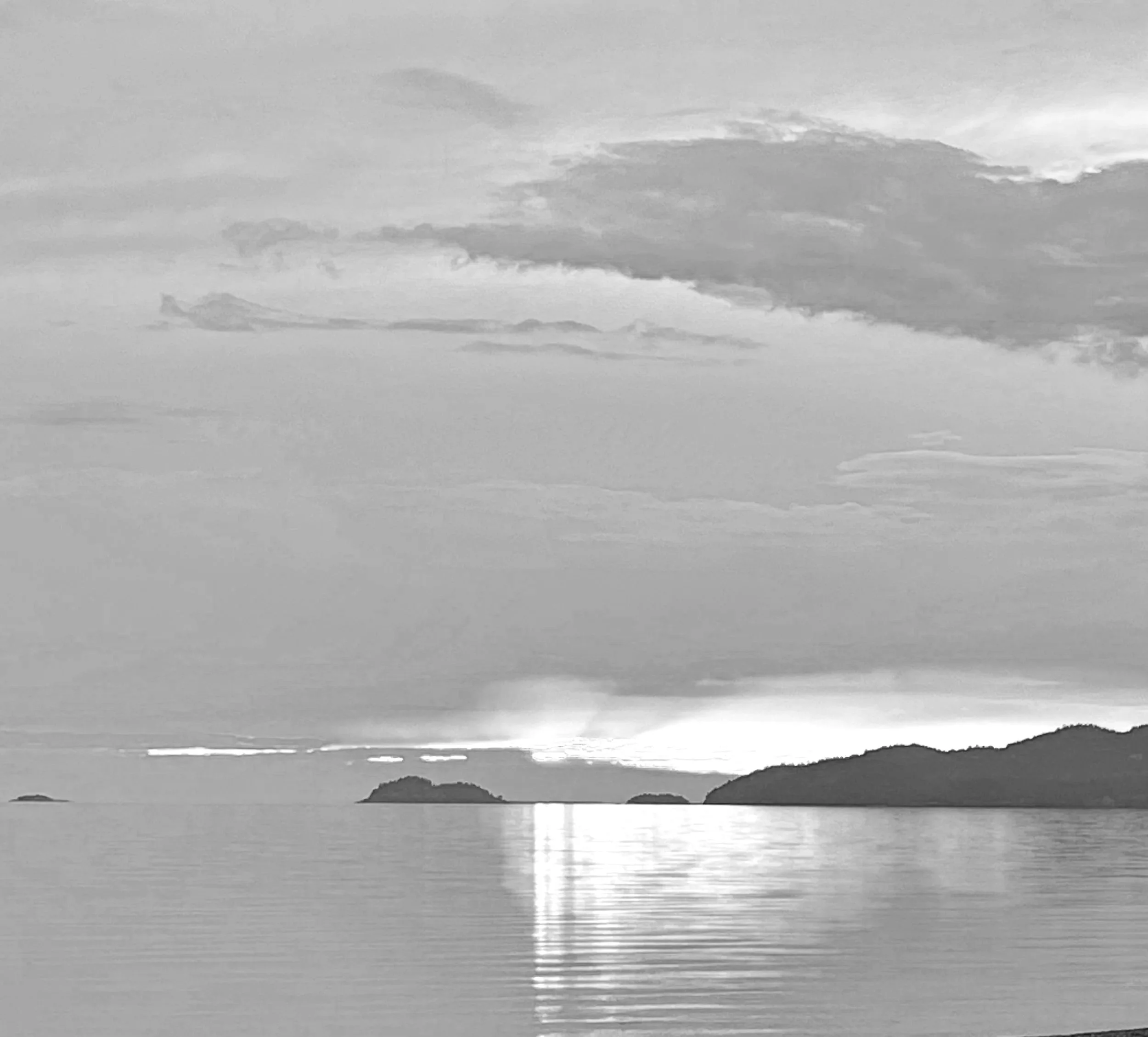 Black and white photo of a calm sunset over Georgian Bay, where Amy Tremblay offers couples retreats and intensives.