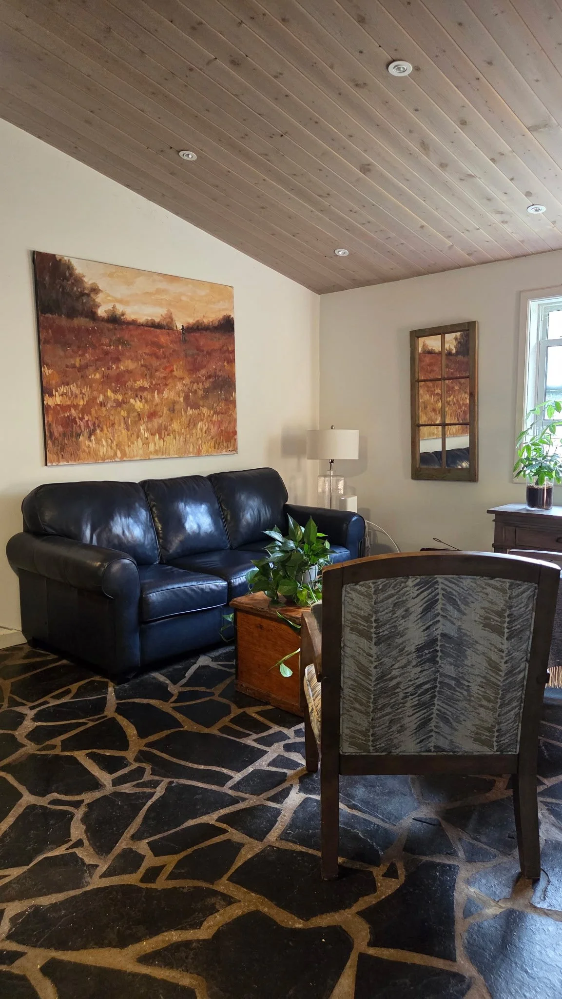 A warm, welcoming therapy space for Amy Tremblay with a leather sofa and soft furnishings.