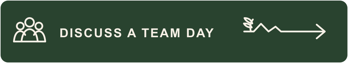 Green sign with white icons and text that reads 'Discuss a Team Day' with icons of a group of people and an arrow.