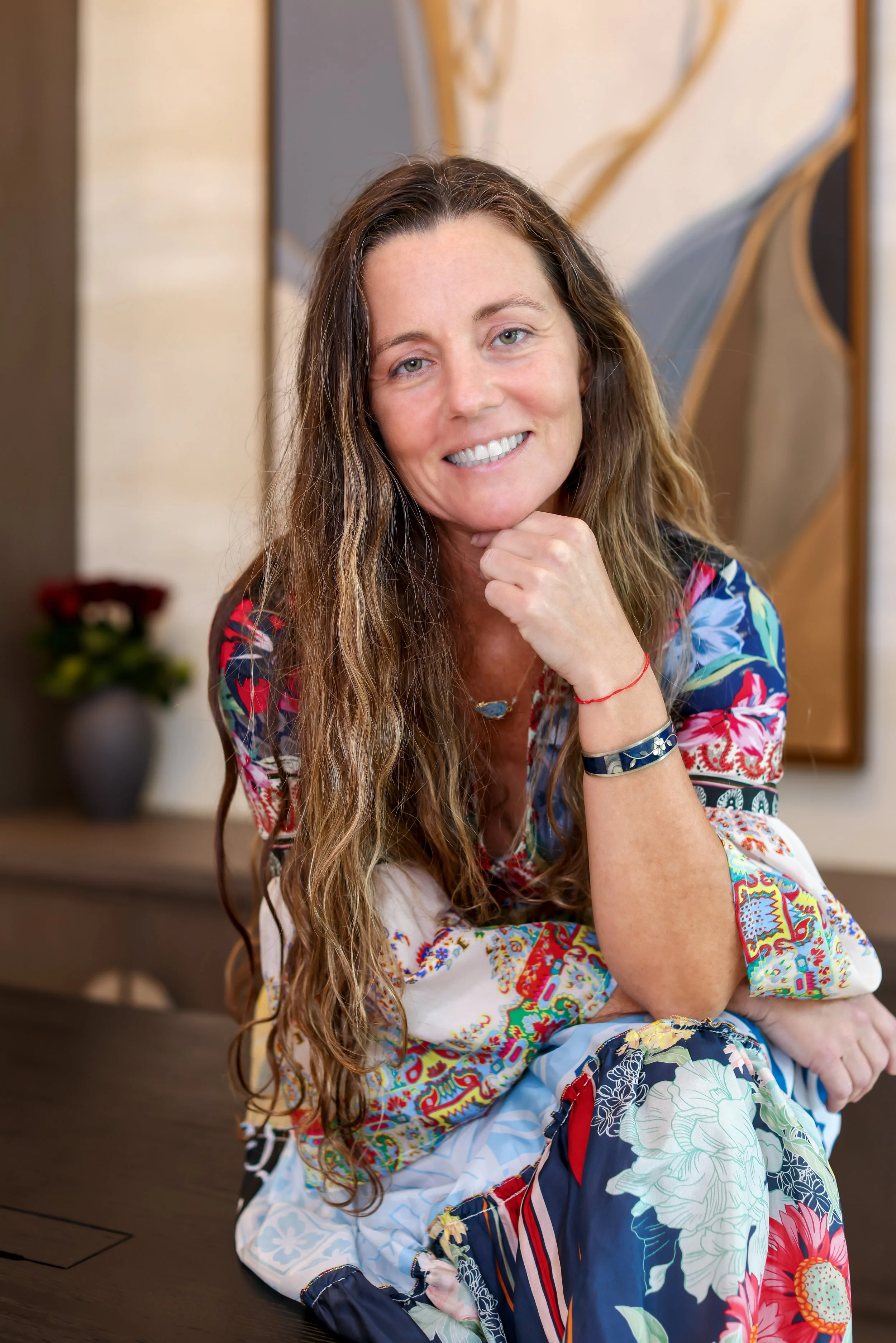 Portrait of Dr. Dawn Murrin, licensed acupuncturist, in a colorful floral top