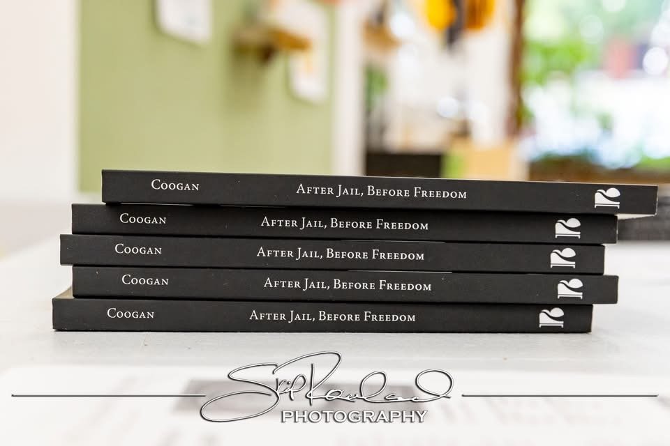 Five copies of the book titled 'After Jail, Before Freedom' by Coogan are stacked horizontally on a white surface. The image also displays a watermark for S. Paul Lee Photography.