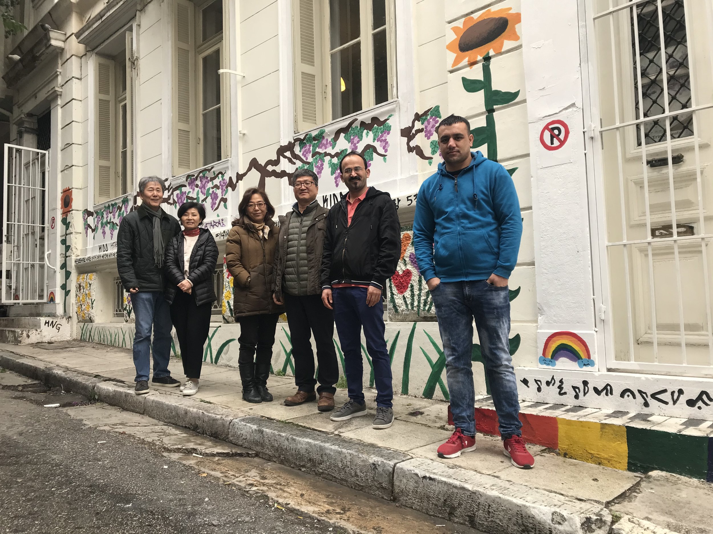 Fred and Kelly Shin with a Korean missionary couple and two GMU MDiv students outside the first ministry space in Exarcheia, Athens, in January 2020