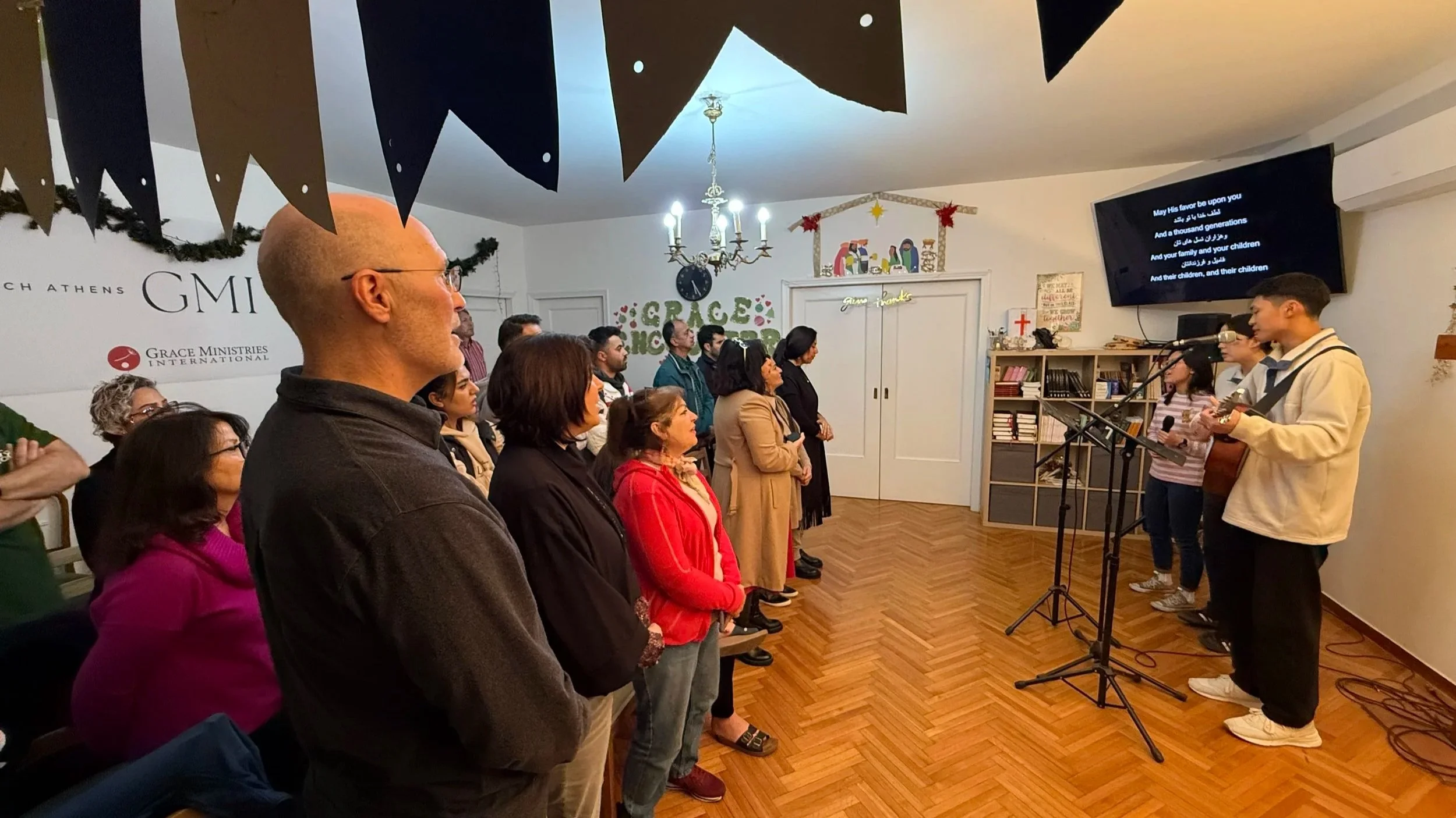 at Athens Grace Church, singing and sharing faith across cultures and backgrounds.Refugee young adults and volunteers worshiping together at Athens Grace Church.