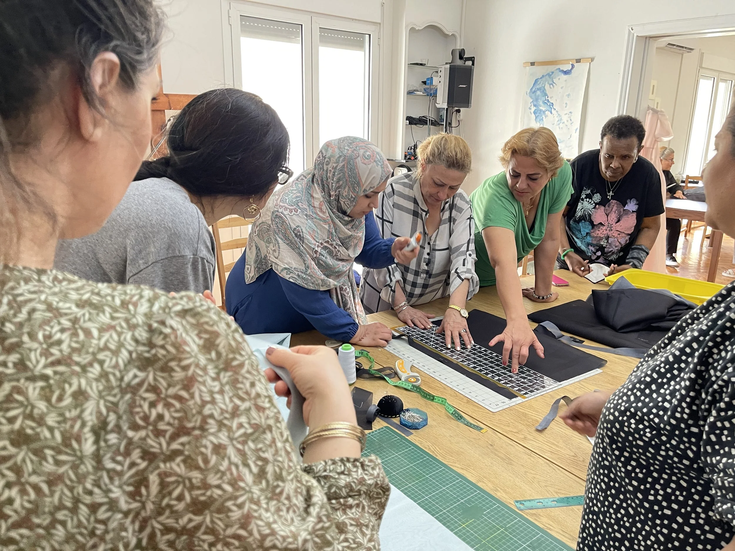 Refugee and migrant women learning sewing and modern Hanbok-making skills together in Athens, Greece.
