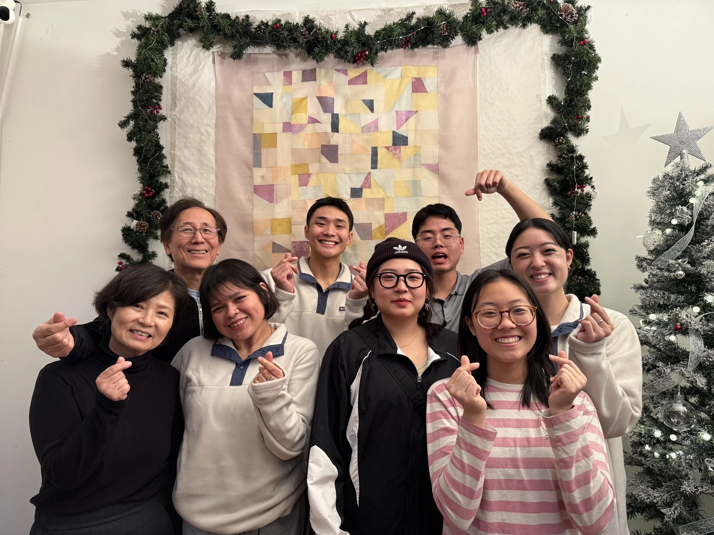 Volunteers and refugee community members taking a joyful group photo at Athens Grace Church.