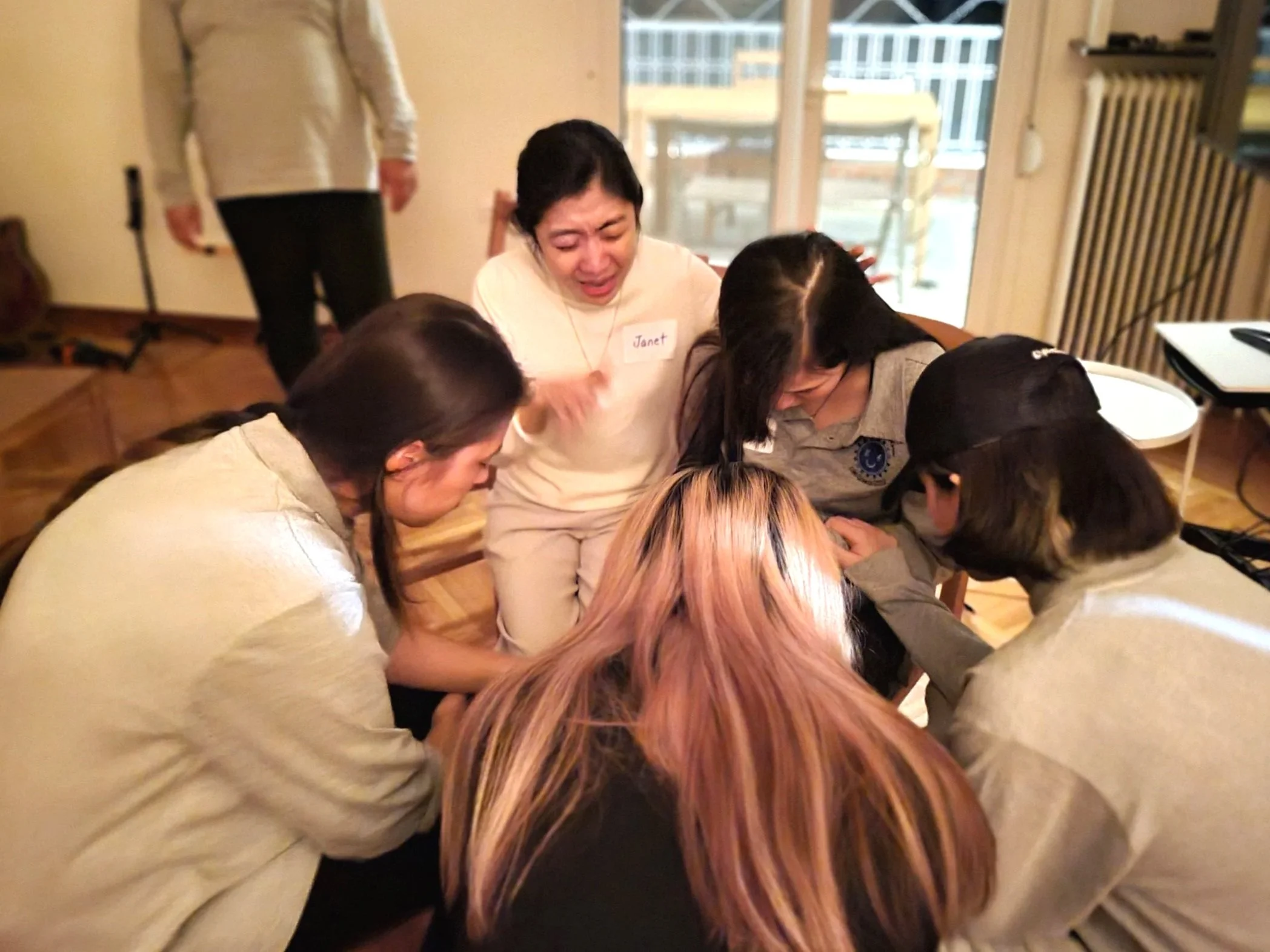 Believers praying together in a Home Church gathering, encouraging and caring for one another in faith.