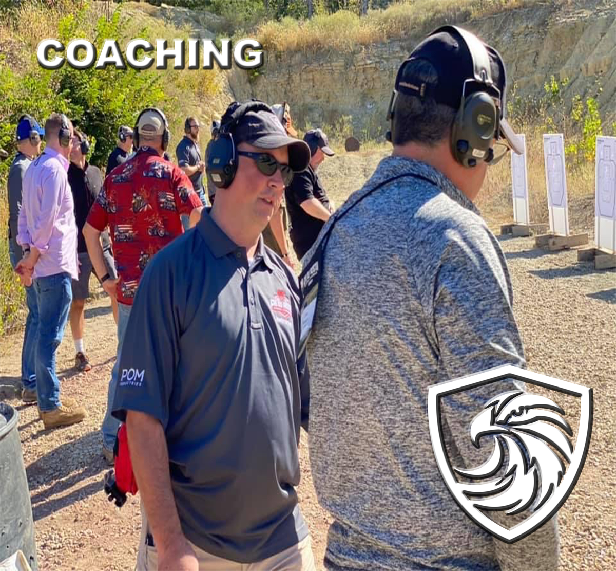 Group of people at a firing range practicing shooting, with targets set up in the background. The word 'COACHING' is written in large letters at the top left, and a logo of a shield with a stylized eagle head is in the bottom right corner.