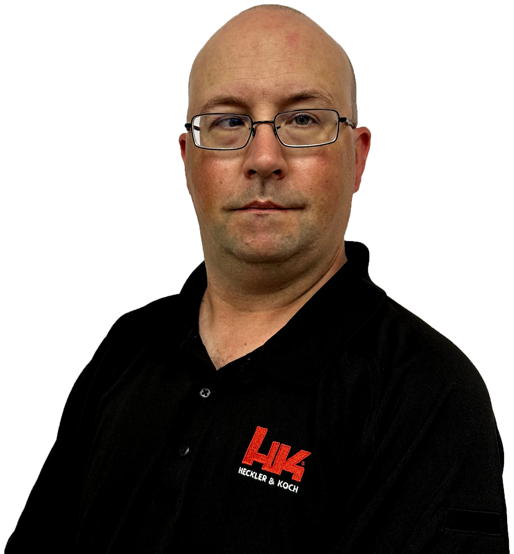 A man with glasses dressed in a black shirt with a red logo that reads 'Heckler & Koch' on the front.