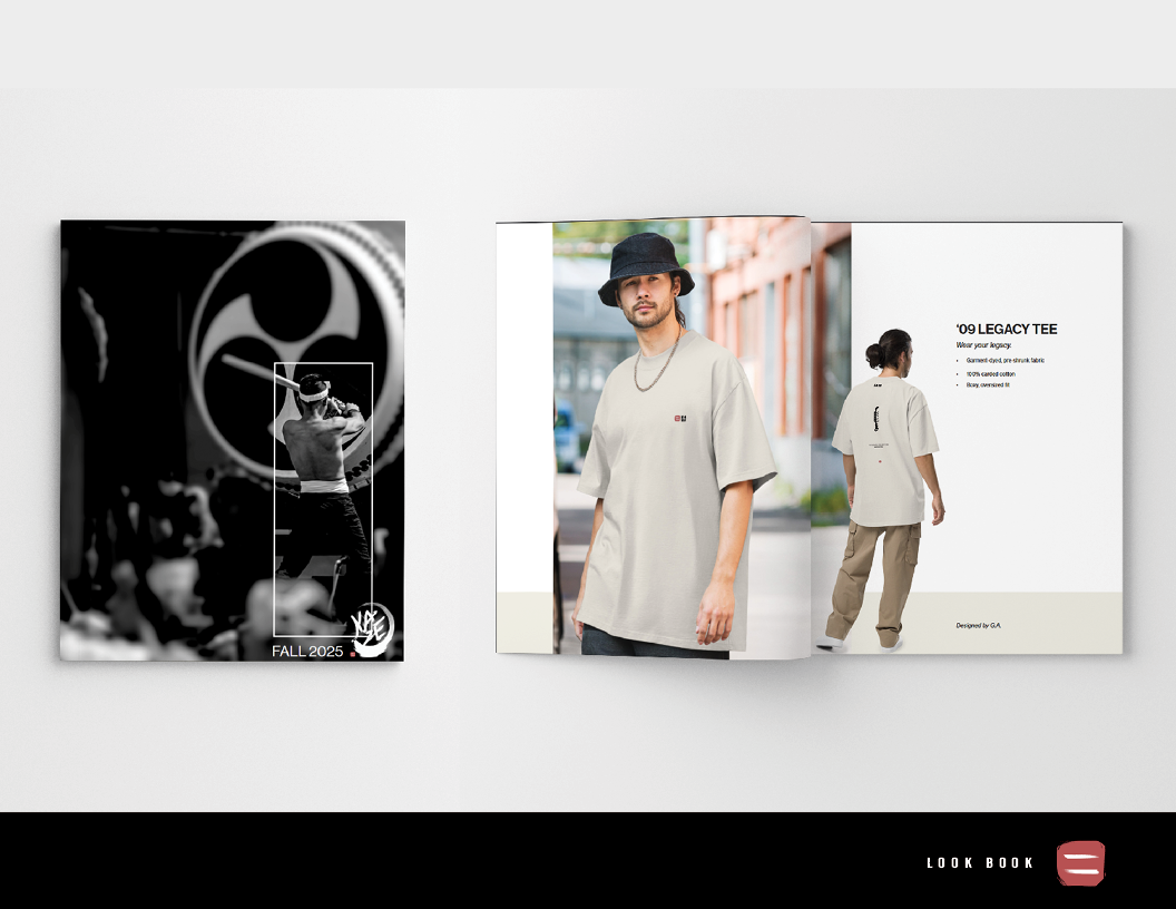 Open fashion catalog showing two pages: the left page features a black-and-white photograph of a man sitting on a chair in front of a large circular design, with the text 'FALL 2025,' and the right page displays a full-color image of a man in a beige