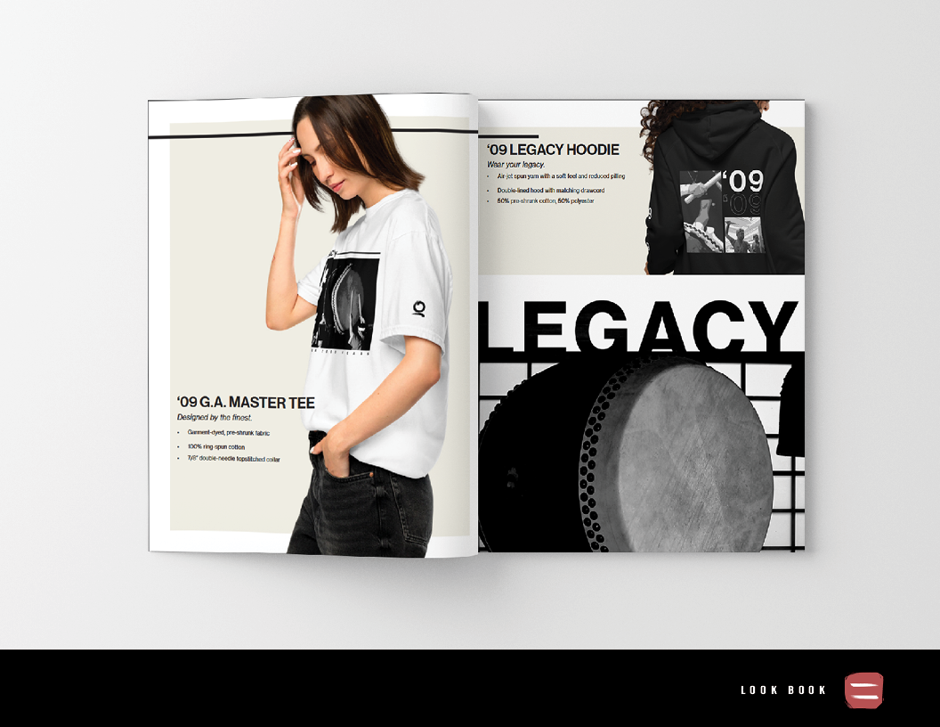 Open magazine featuring clothing, with a woman wearing a white graphic t-shirt on the left and a black hoodie on the right, background is plain white.