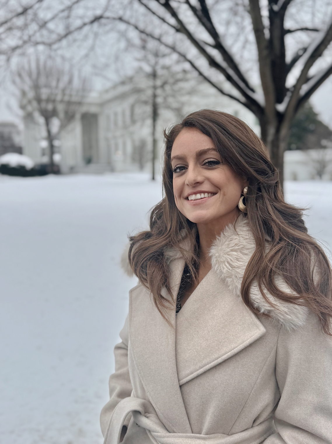 Mary Margaret Olohan smiles in front of the White House.