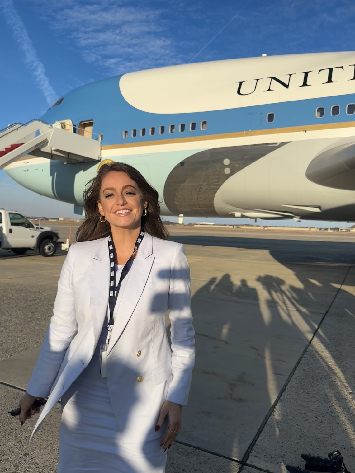 Mary Margaret Olohan smiles for a photo in front of Air Force One at JBA.
