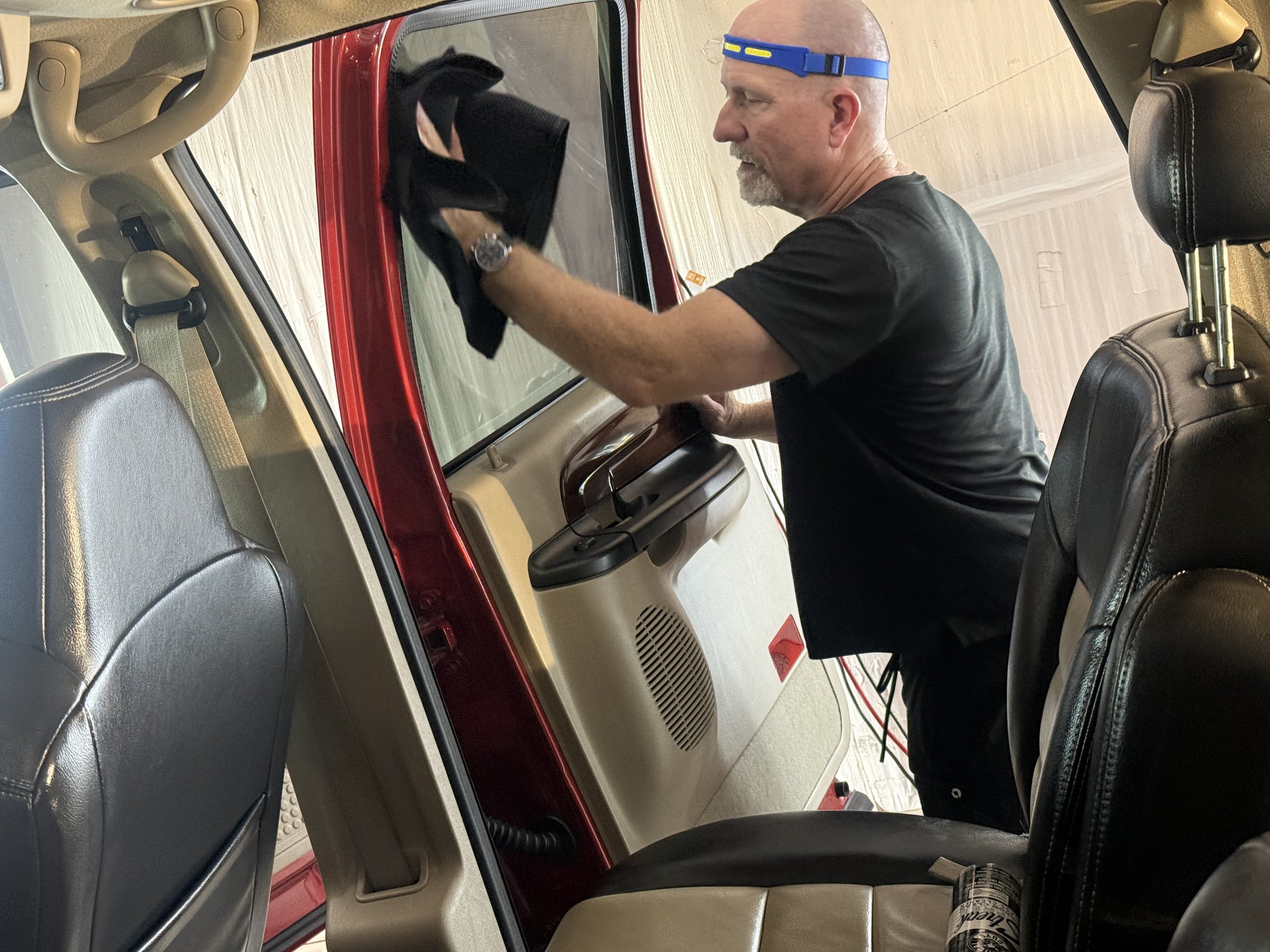 A man detailing a car.