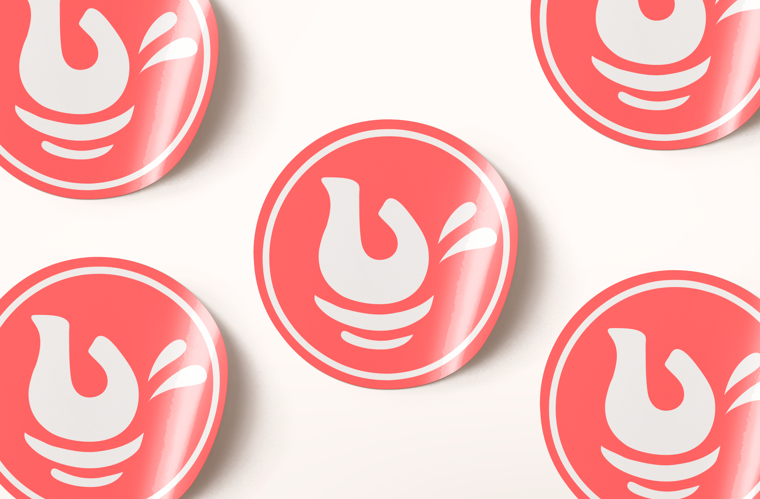 Close-up of multiple pink stickers with submark logo