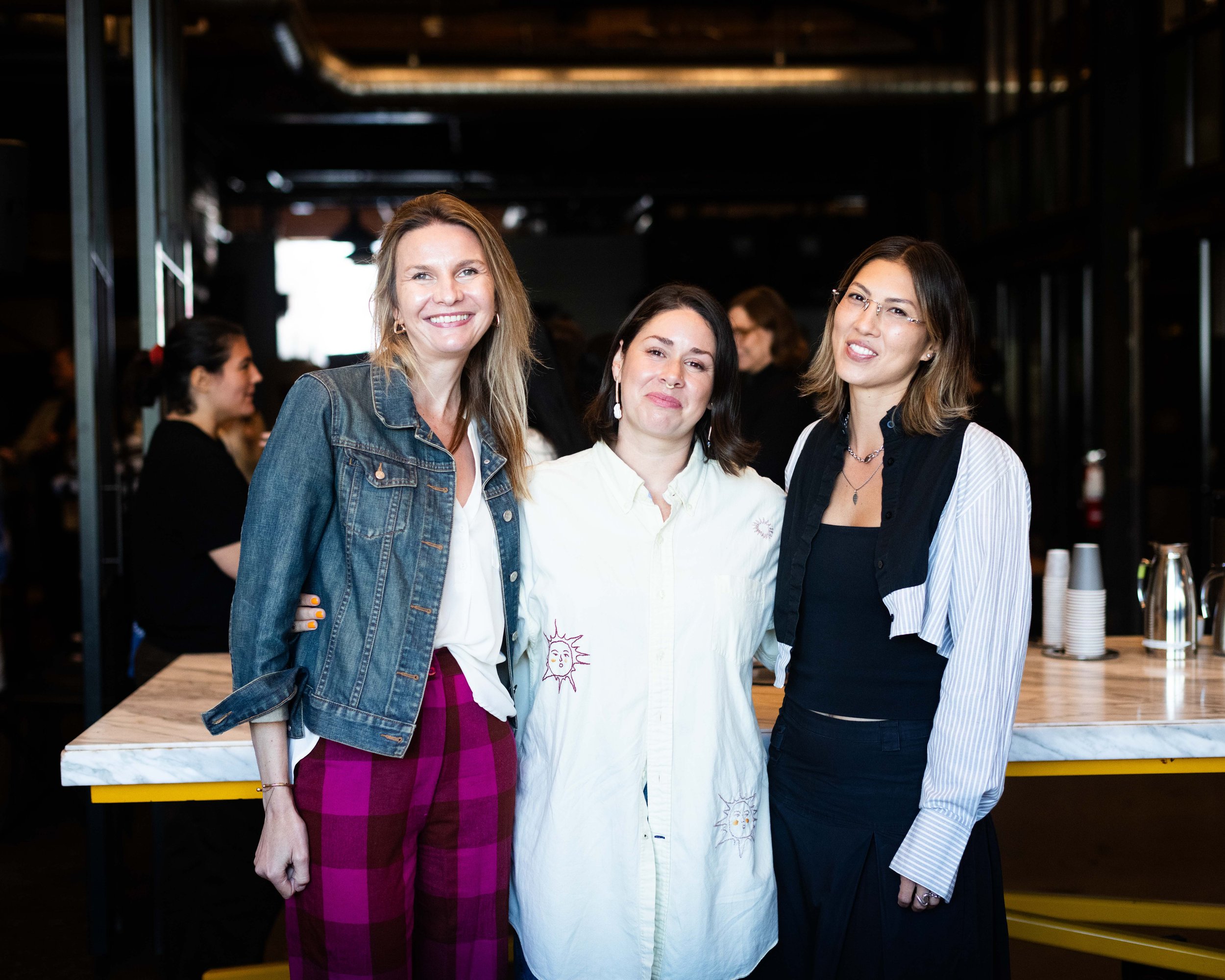 Three women standing in a room