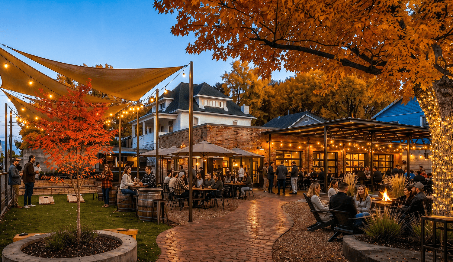 The beer garden at Sloan’s Station at dusk, with string lights, fire pits, lawn games, and a covered patio