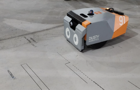 Construction worker using a tablet with AI-powered inspection technology on an active jobsite