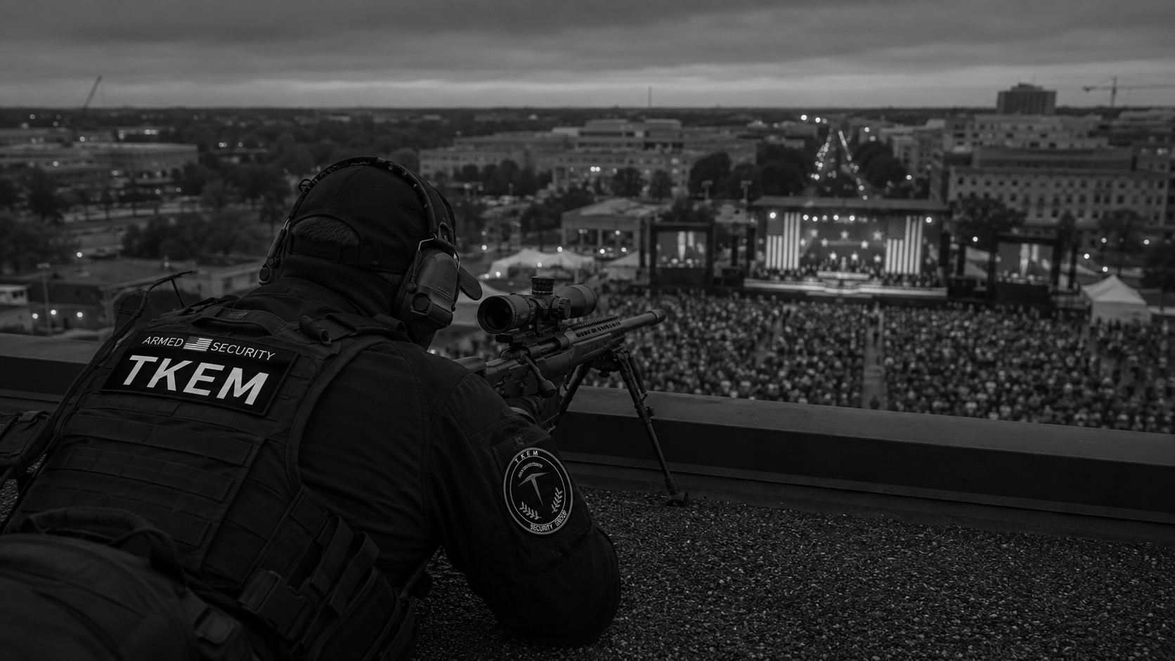 A security officer with tactical gear, binoculars, and a long rifle observes a large crowd at an outdoor concert stage with American flags, under cloudy skies in a cityscape at dusk.