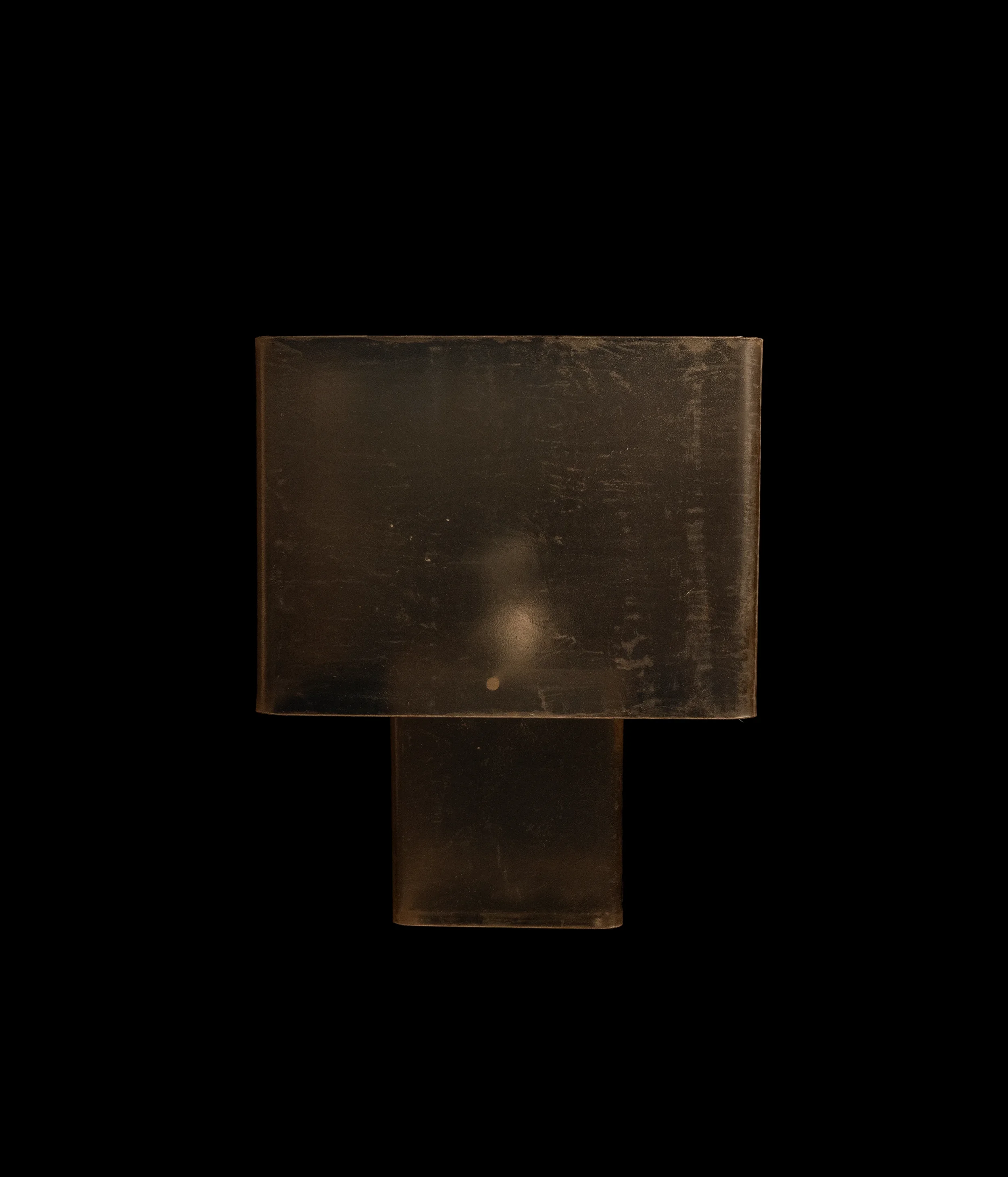 RACAANA sculptural leather art lamp occupying a dark architectural interior with quiet, intimate presence.