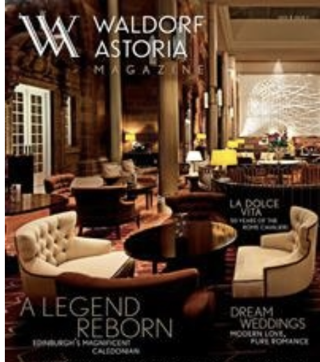 Cover of Waldorf Astoria Magazine featuring a luxurious hotel lobby with plush seating, warm lighting, and a cozy fireplace in the background.