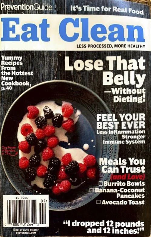Magazine cover titled "Eat Clean" with a subtitle "Less Processed, More Healthy." Features include recipes, tips for losing belly fat without dieting, boosting immune health, trustworthy meals, and healthy breakfast options like burrito bowls, banana