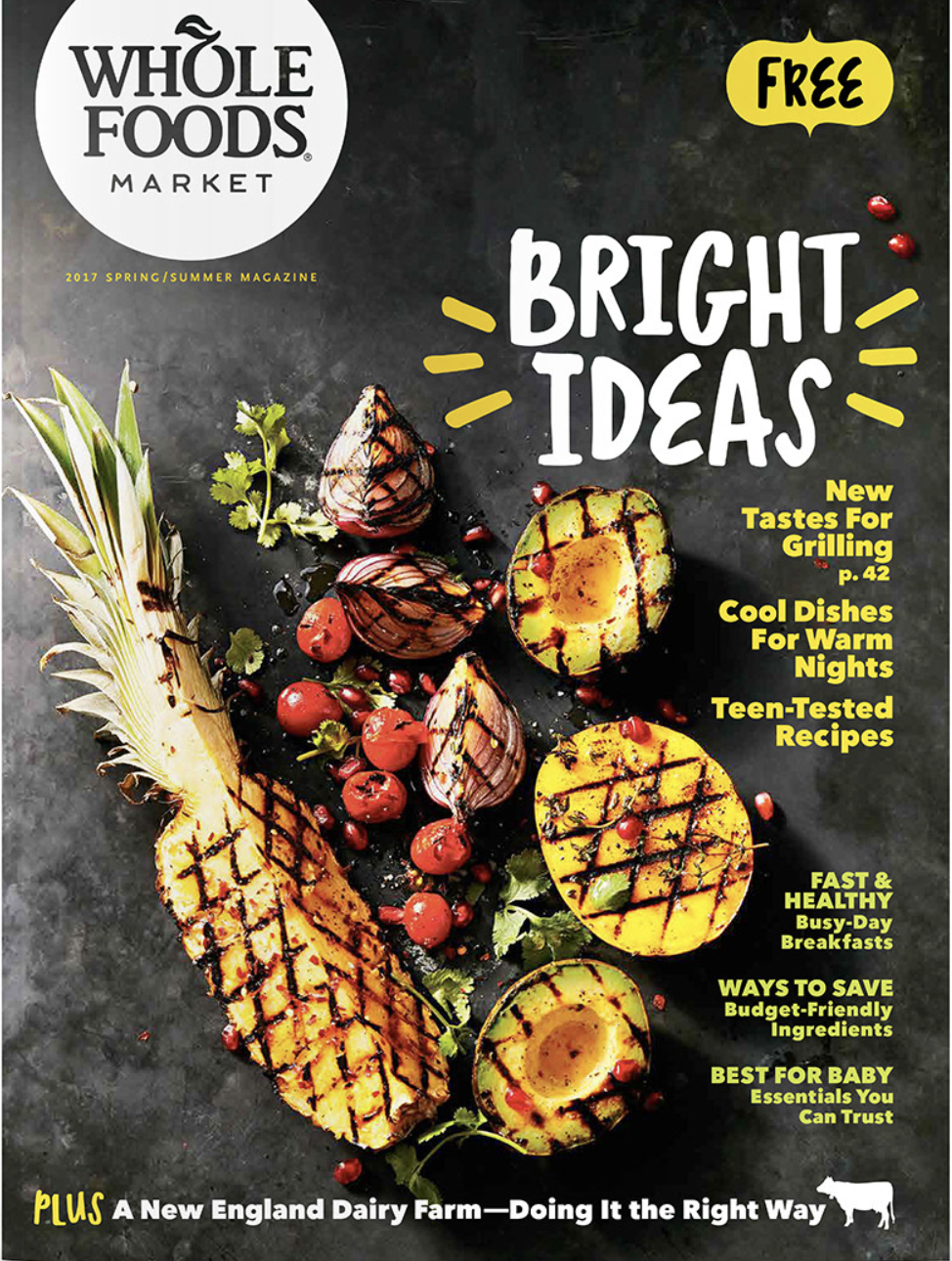 Magazine cover for Whole Foods Market Spring/Summer 2017 issue featuring grilled pineapple, grilled peaches with a core, and grilled onion slices garnished with pomegranate seeds and herbs.