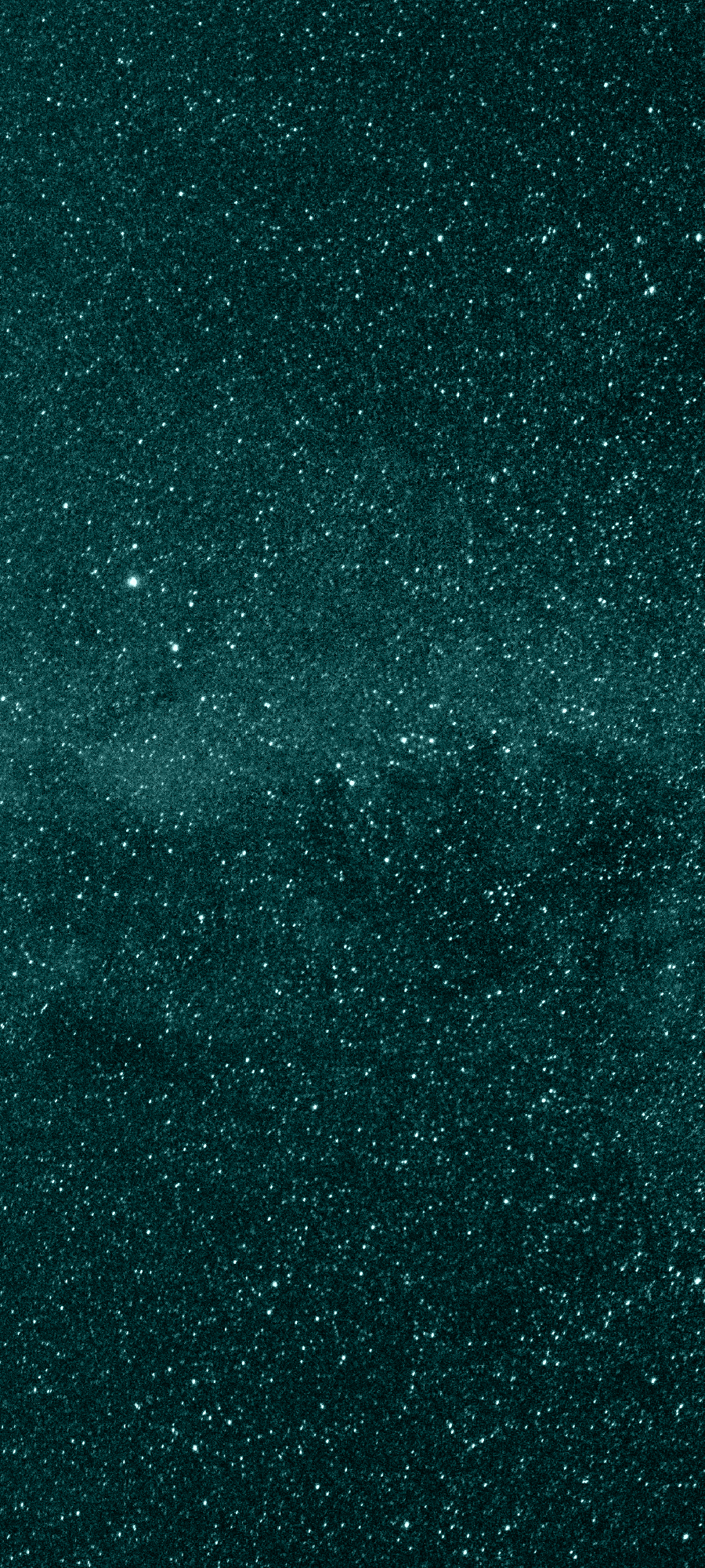 A close-up view of a starry night sky with numerous small, bright stars scattered across a dark, greenish background.