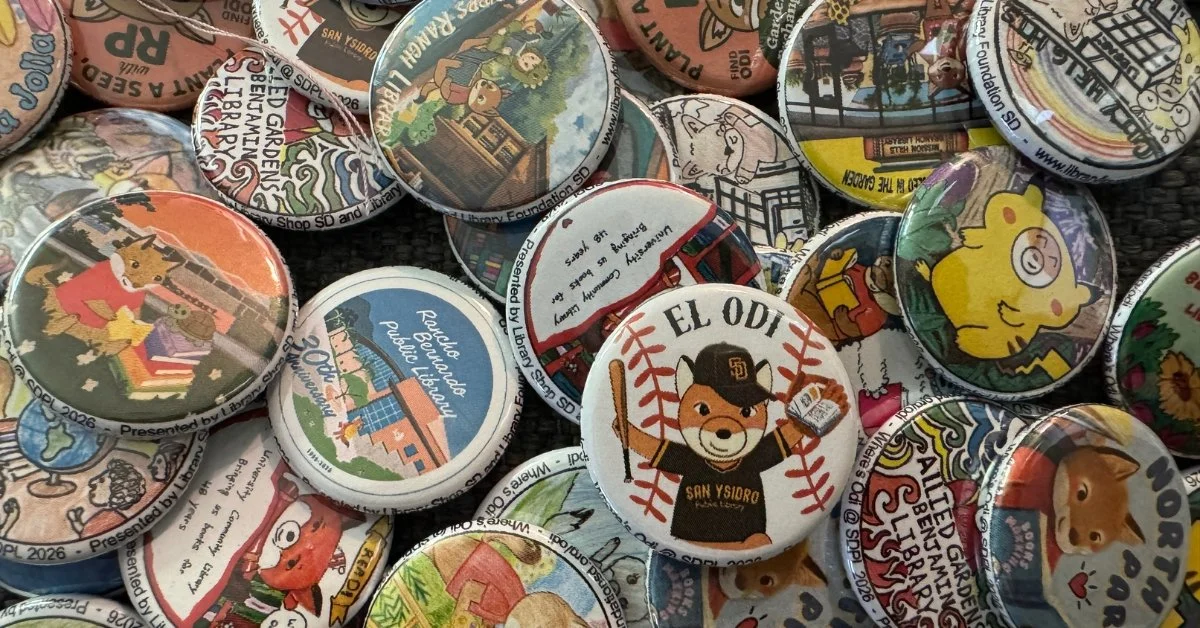A collection of colorful buttons  from the Where's Odi challenge. The buttons mostly feature Odi, but some feature the specific library branch they represent.