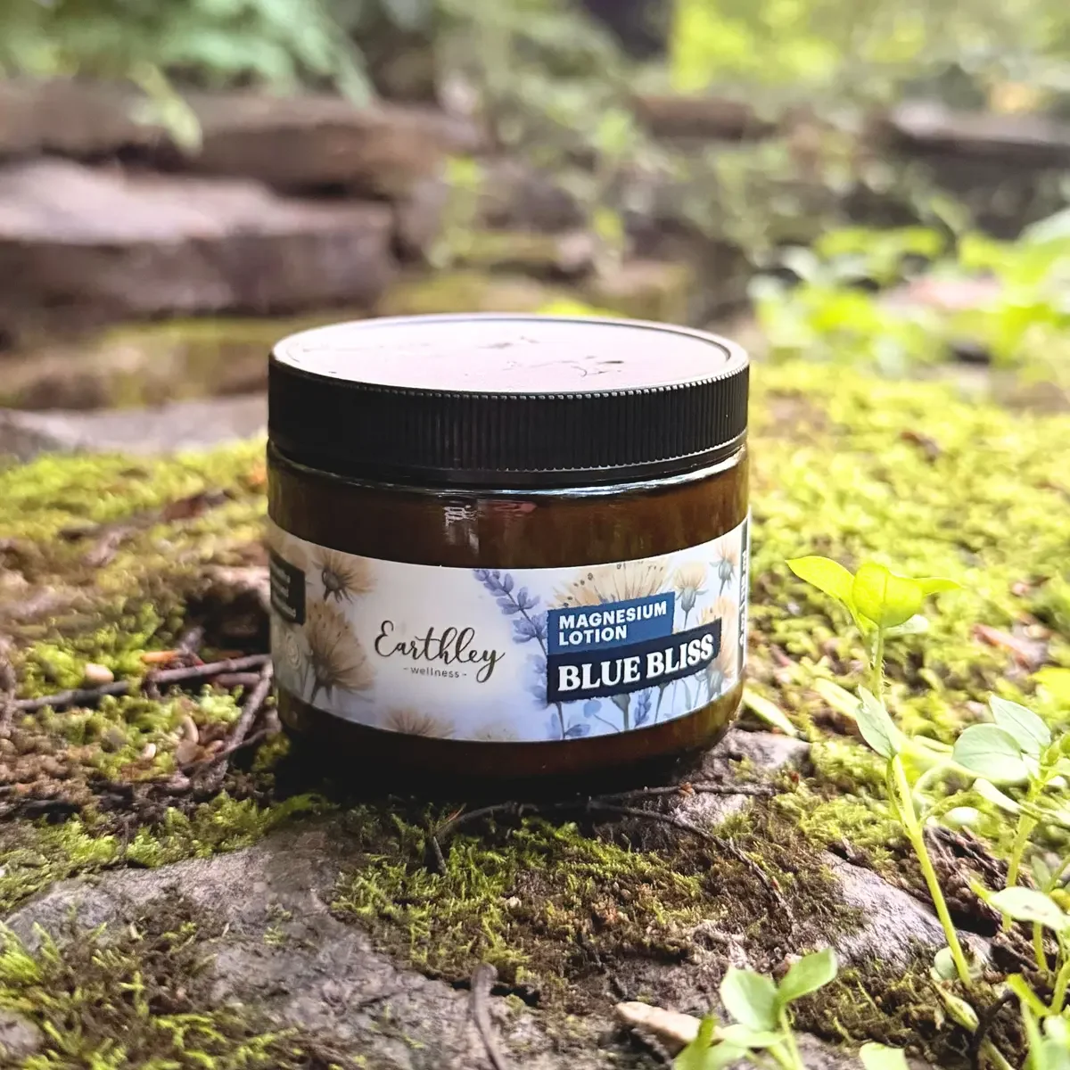 A small jar of Earthley Wellness Magnesium Lotion labeled Blue Bliss.
