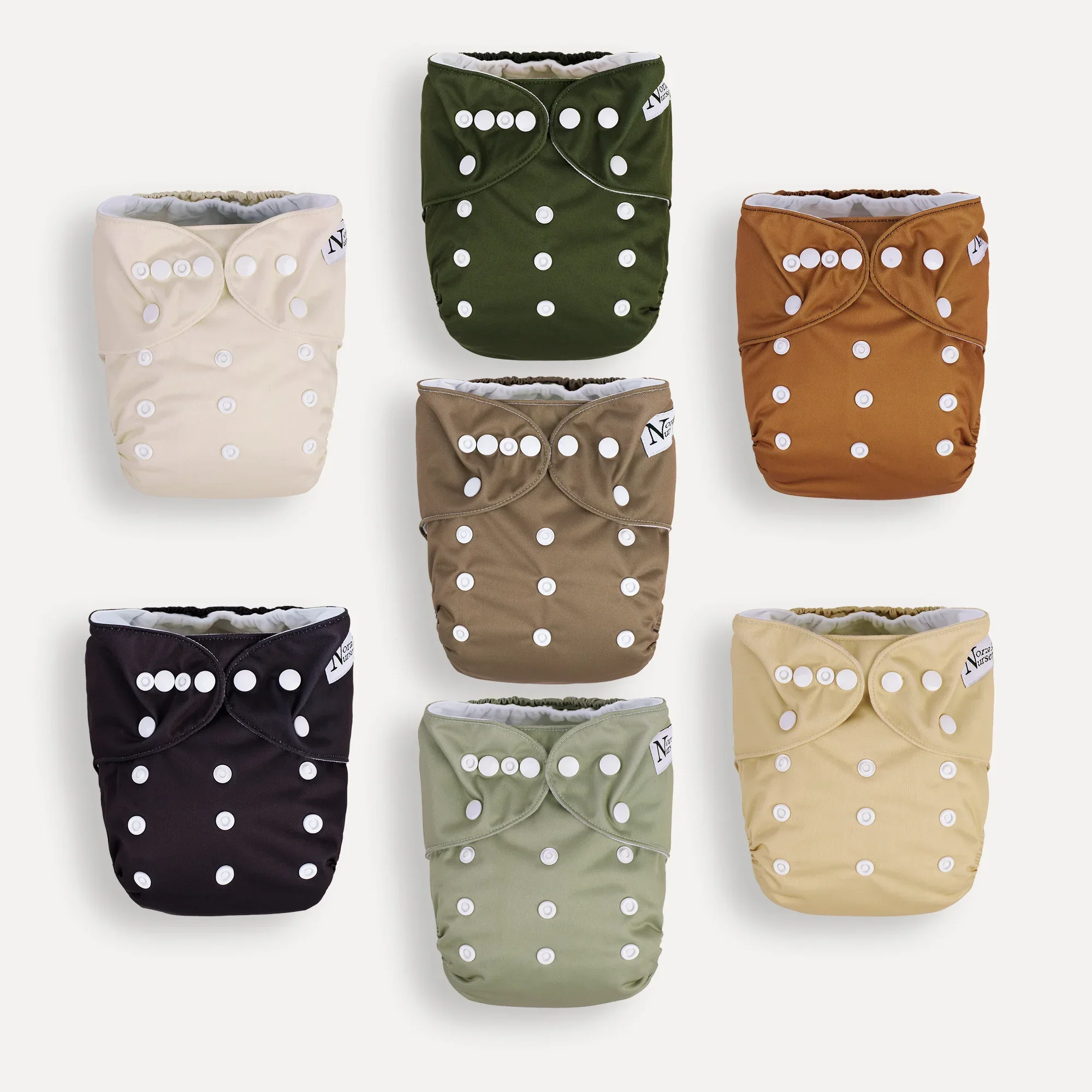 Reusable cloth diapers in various colors, including cream, dark green, tan, black, olive green, and yellow.