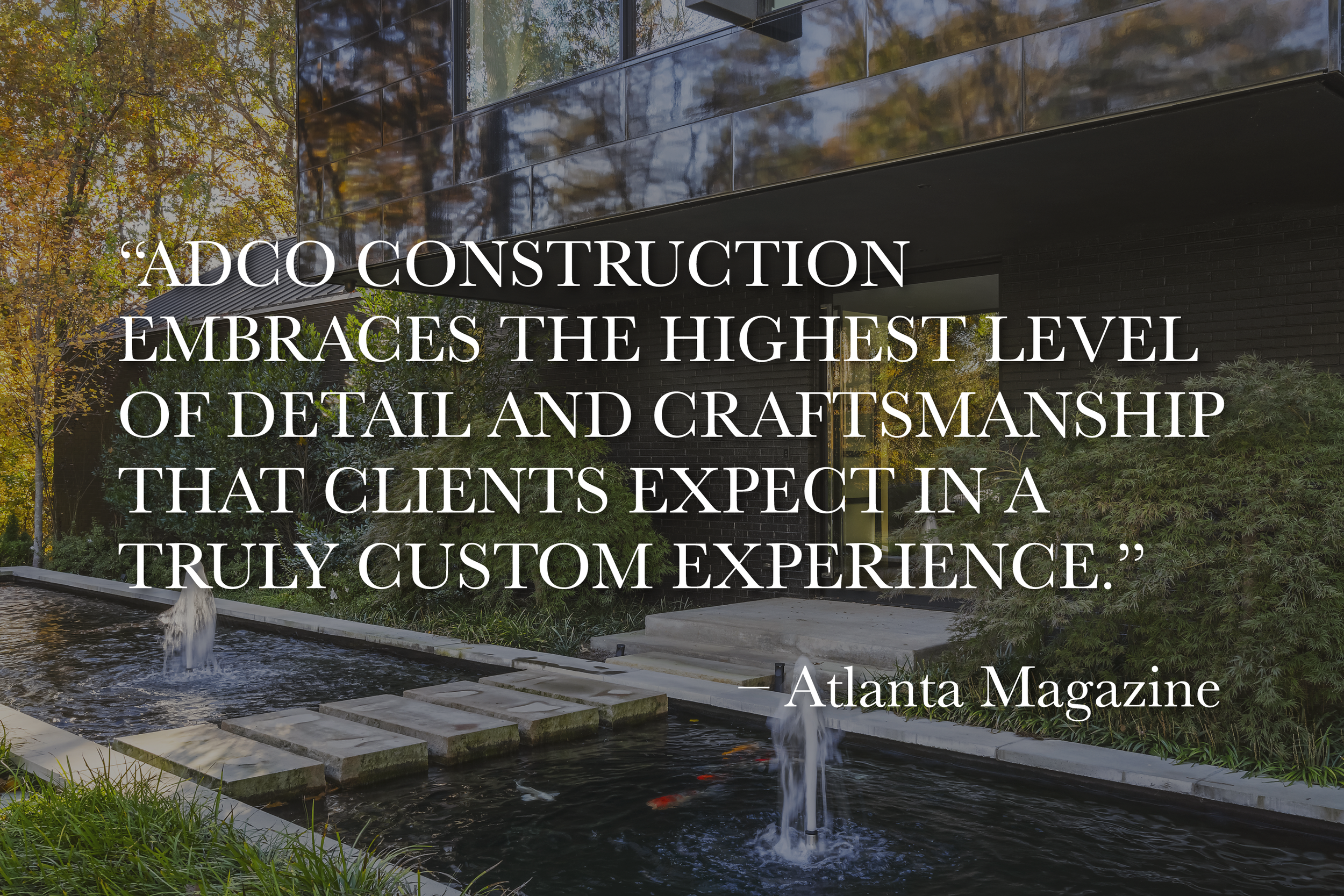 Modern building with reflective black glass exterior, surrounded by colorful autumn trees, with a small water feature and stepping stones in the foreground. Overlaying text quotes Atlanta Magazine about a construction company's attention to detail and craftsmanship.